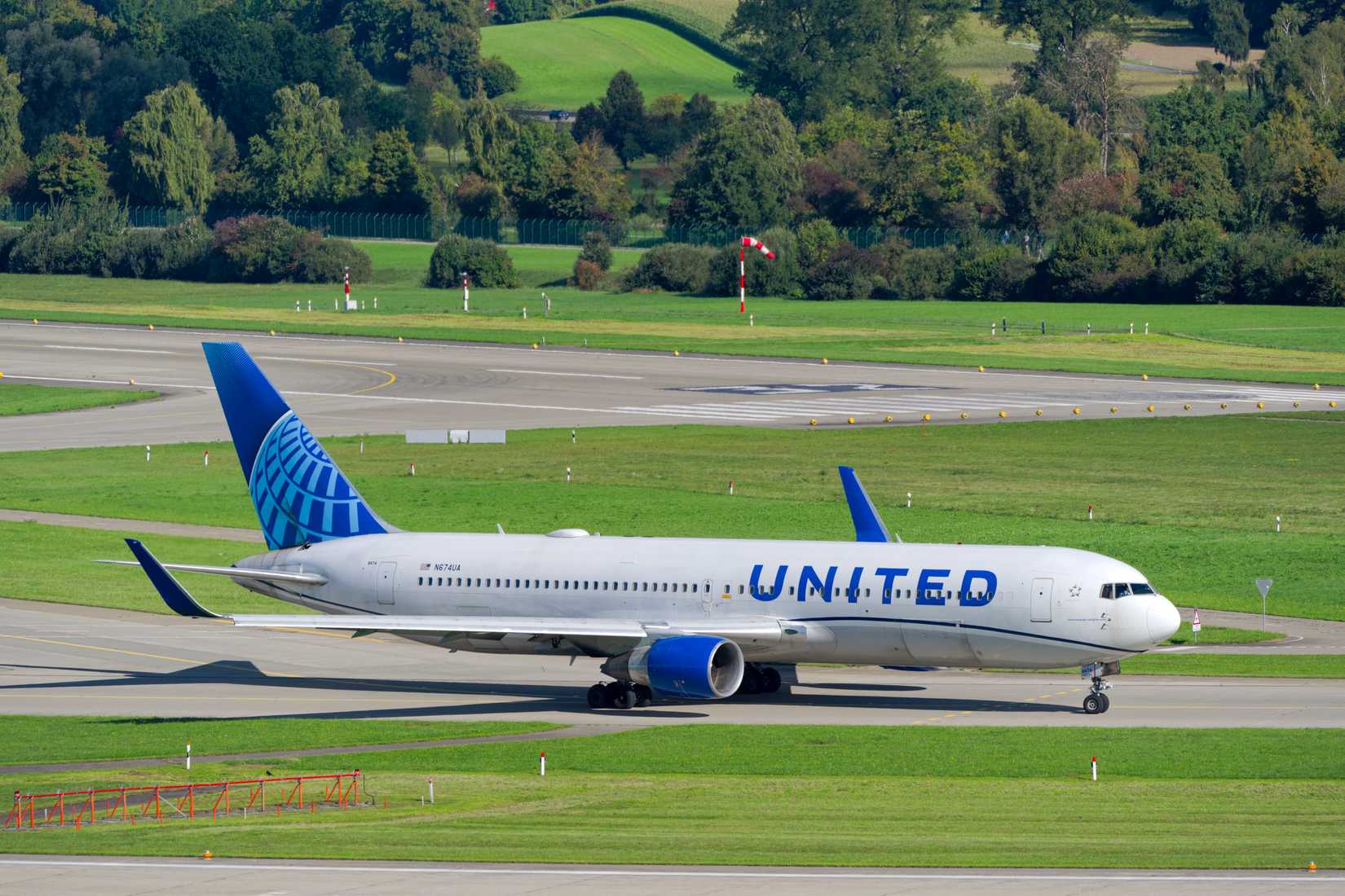 United Airlines passenger airplane Boeing 767-300 registration N674UA leaving Swiss Airport Zürich Kloten on a sunny late summer day.