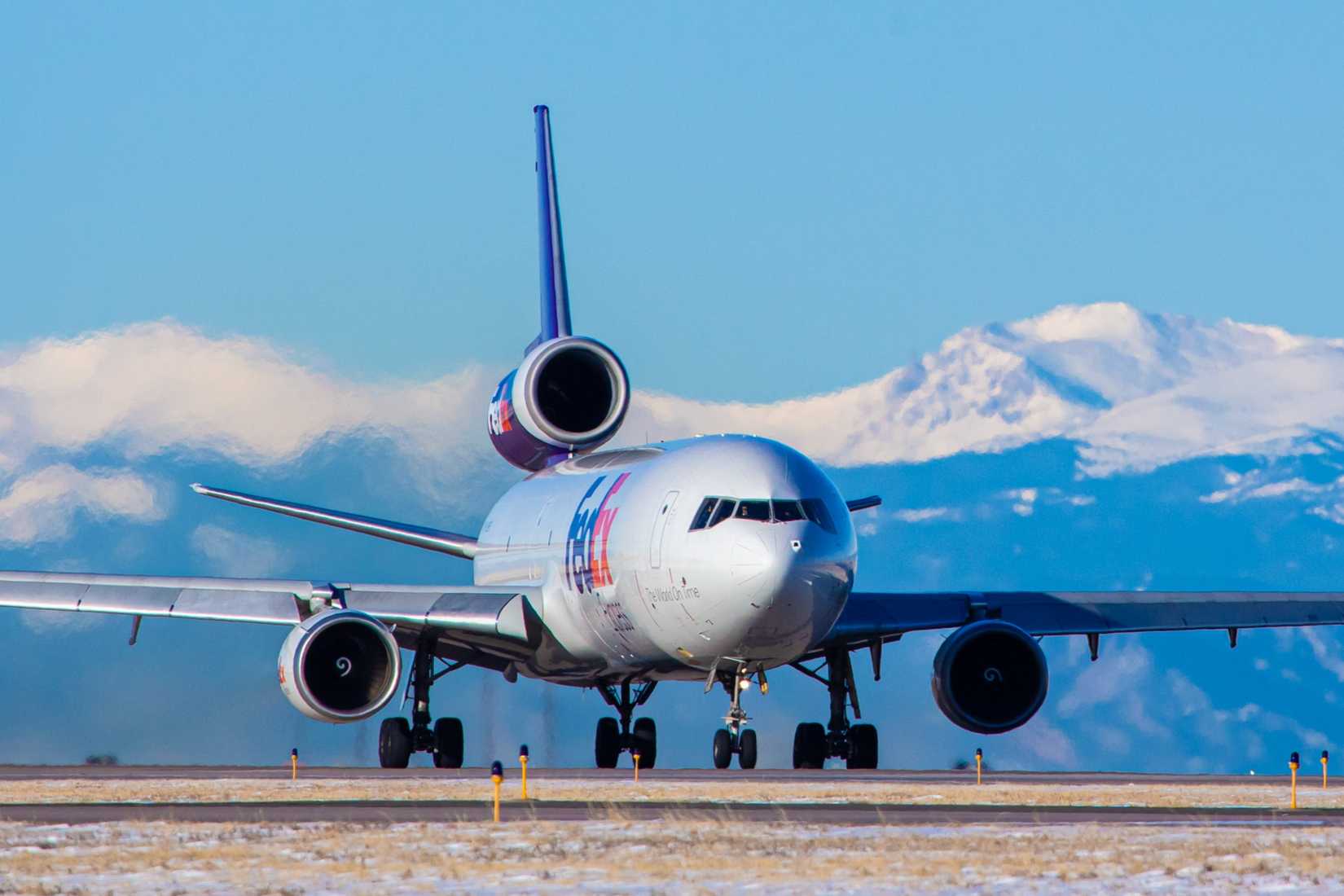 FedEx MD-11 with mountains in background