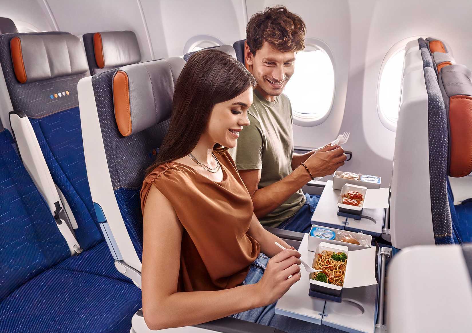 flydubai passengers enjoy meals in the economy cabin of a 737