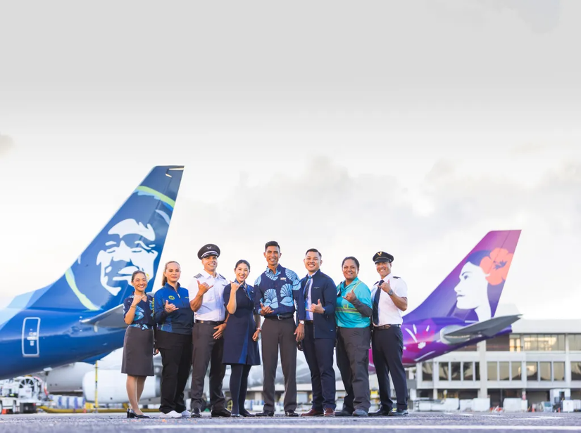 Alaska Airlines & Hawaiian Airlines Staff In Front Of Aircraft Tails