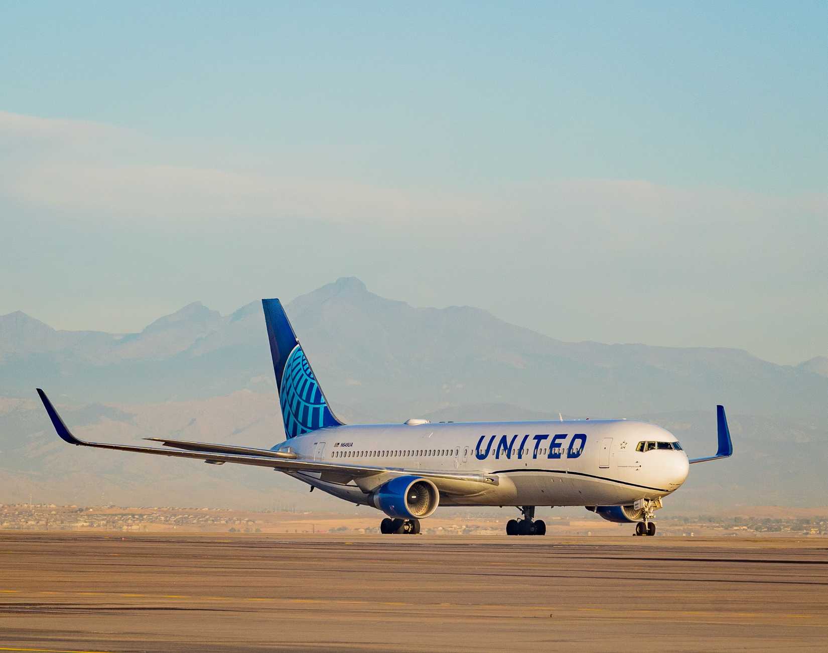 United Airlines Boeing 767 on the ground by mountains