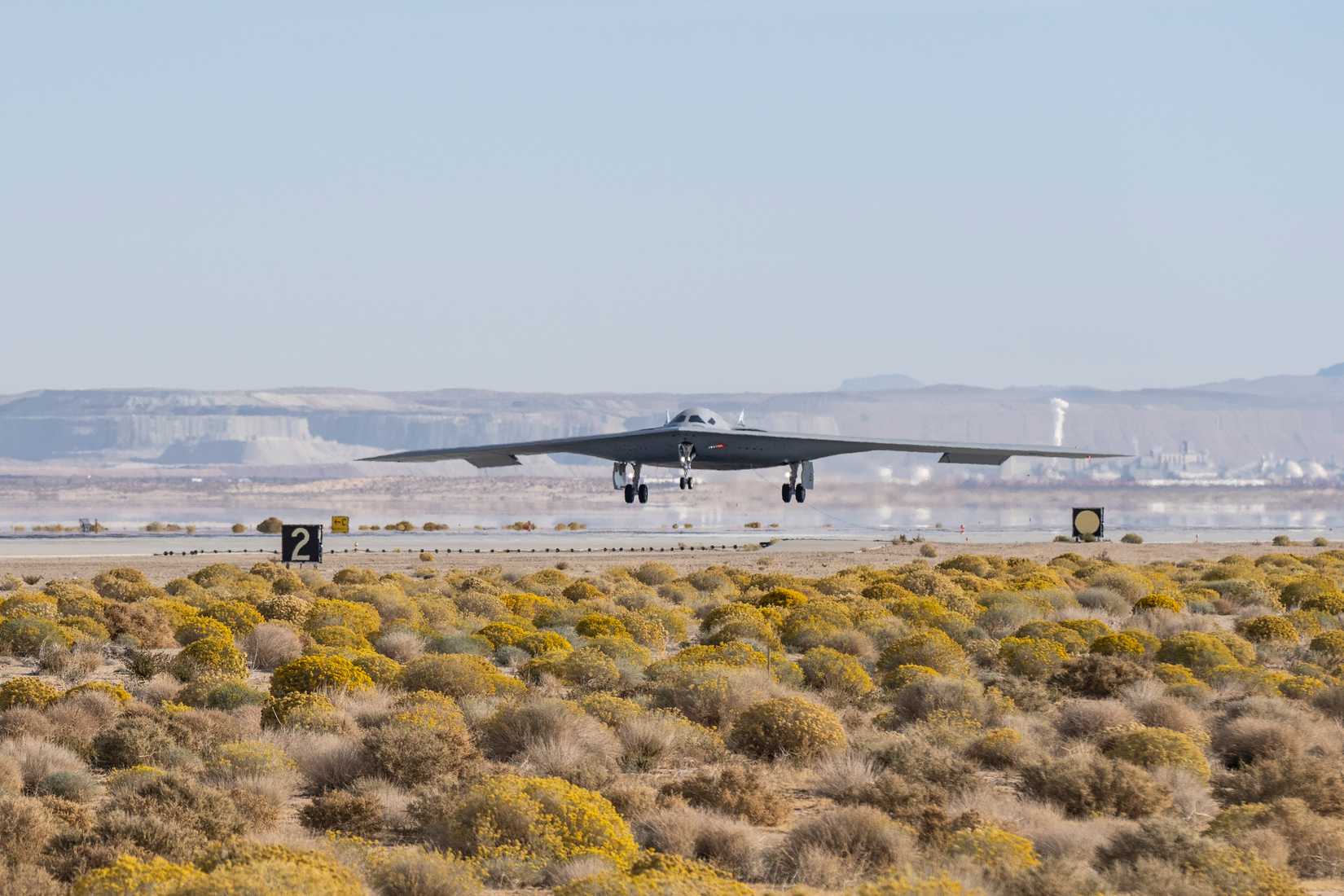 A B-21 Raider conducts flight testing, which includes ground testing, taxiing, and flying operations, at Edwards Air Force Base, California.