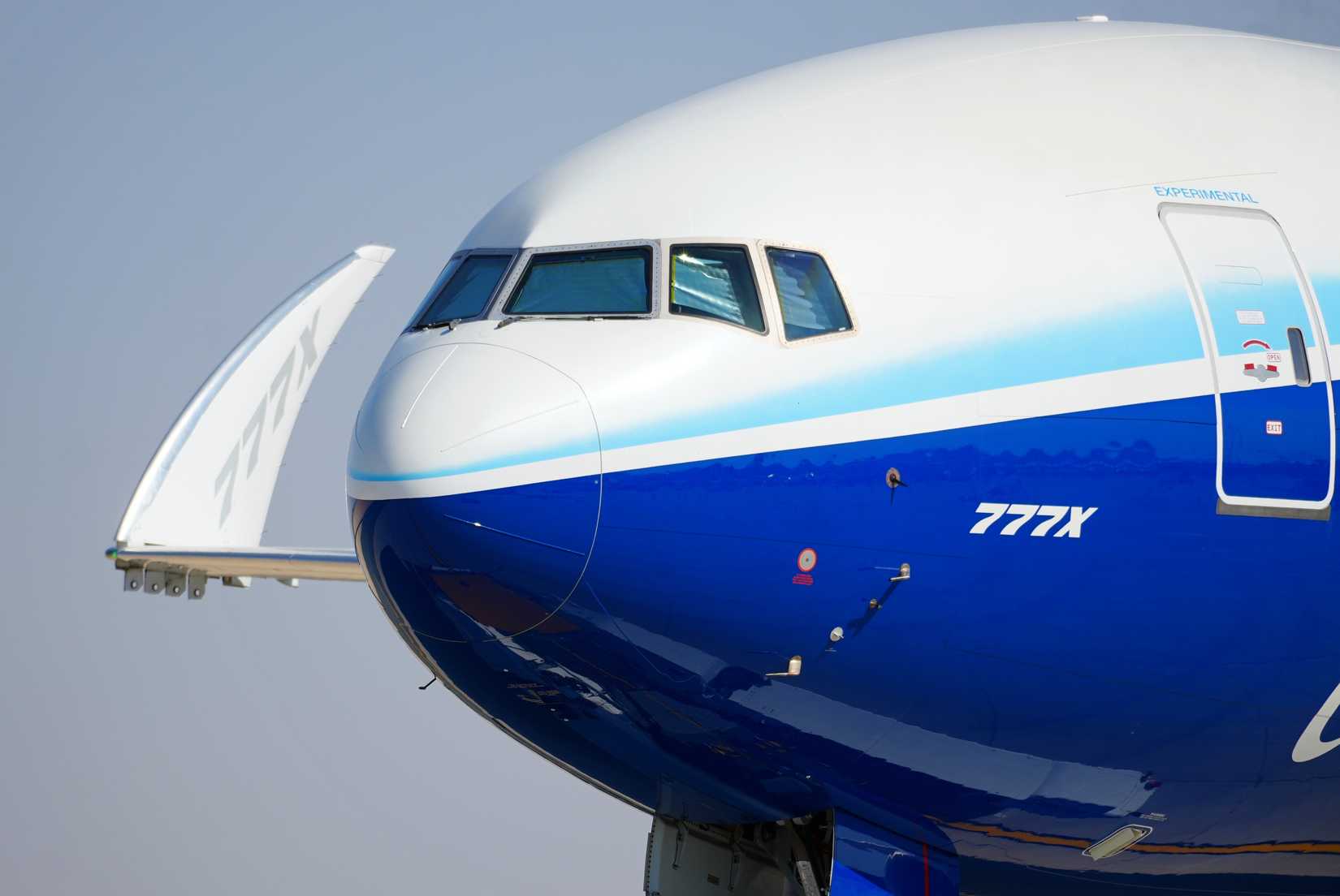 A Boeing 777X flight test vehicle taxis out to the runway for a flying display.
