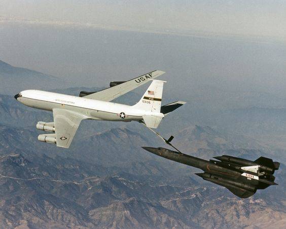 A KC-135 Stratotanker refuels a SR-71 Blackbird at an unknown location.