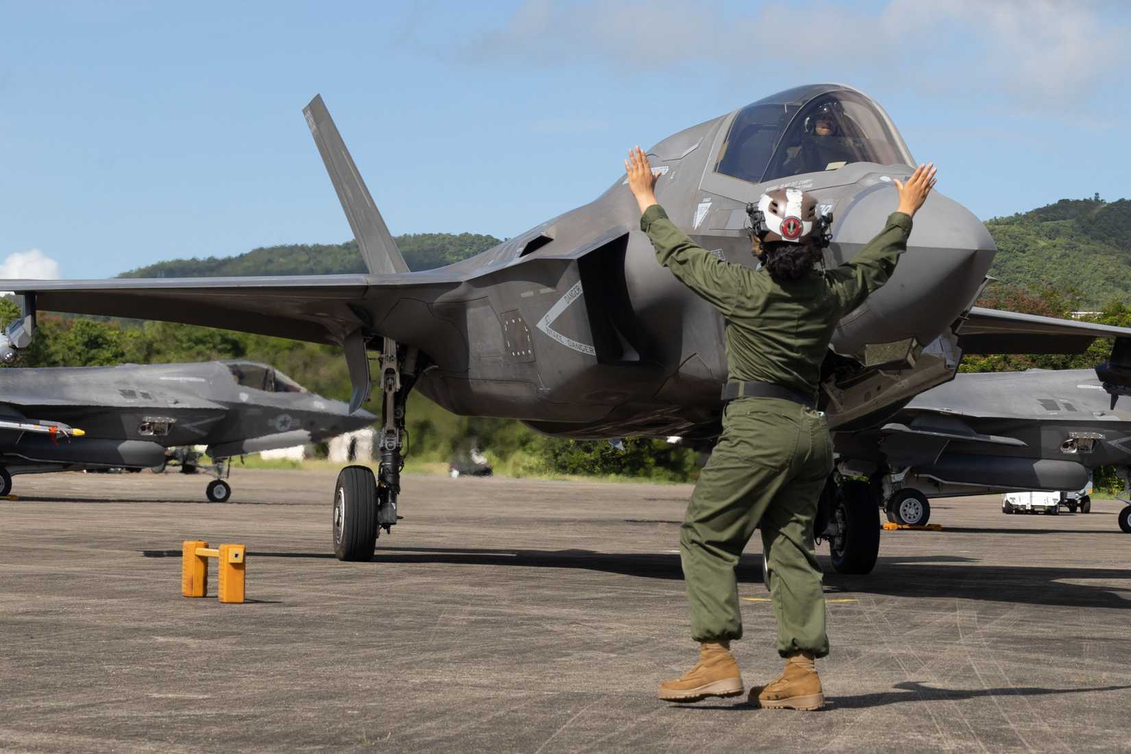 A U.S. Marine with Marine Fighter Attack Squadron 225, U.S. Marine Corps Forces, South, guides a U.S. Marine Corps F-35B Lightning II