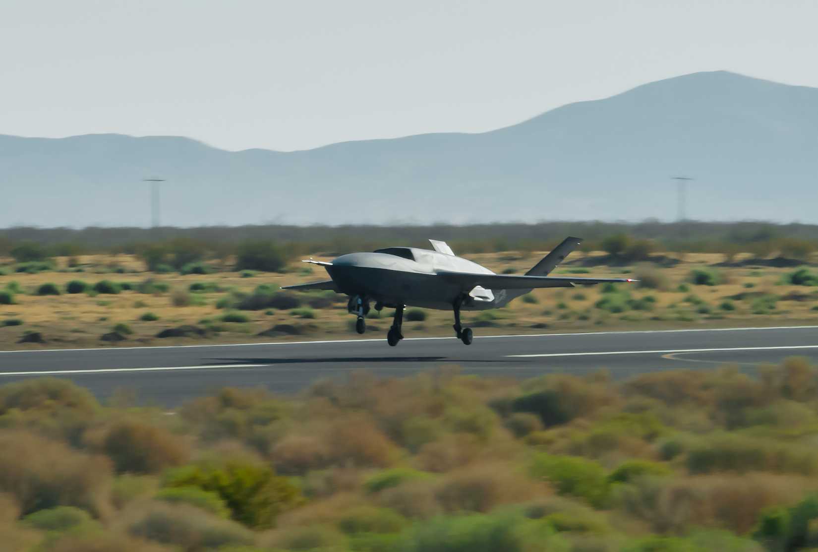 A YFQ-42A Collaborative Combat Aircraft takes off during flight testing at a California test location.