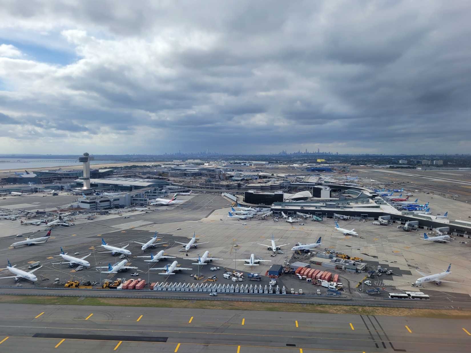 Aerial view of John F. Kennedy International Airport (JFK Airport) on a cloudy afternoon.