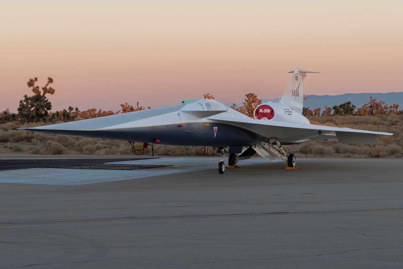 NASA’s X-59 quiet supersonic research aircraft sits on the ramp at Lockheed Martin Skunk Works in Palmdale, California during sunrise, shortly after completion of painting. 