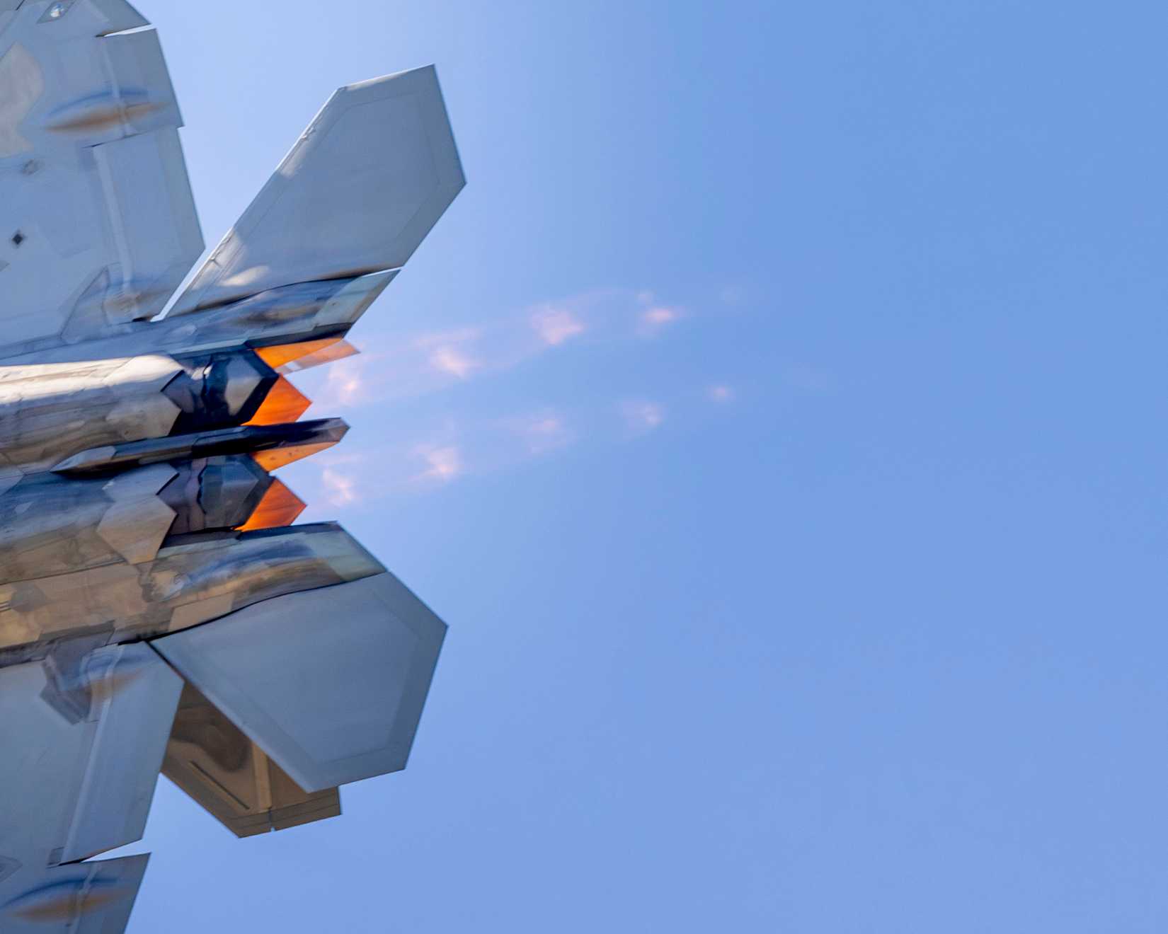 Afterburners are lit as an F-22 Raptor performs an aerial demonstration at the New York Air Show.
