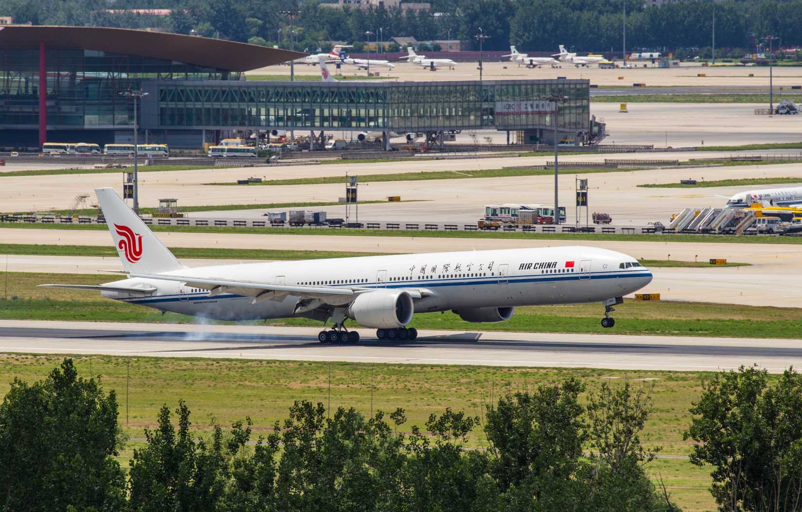 Air China passenger plane touching down at Beijing Capital International Airport.