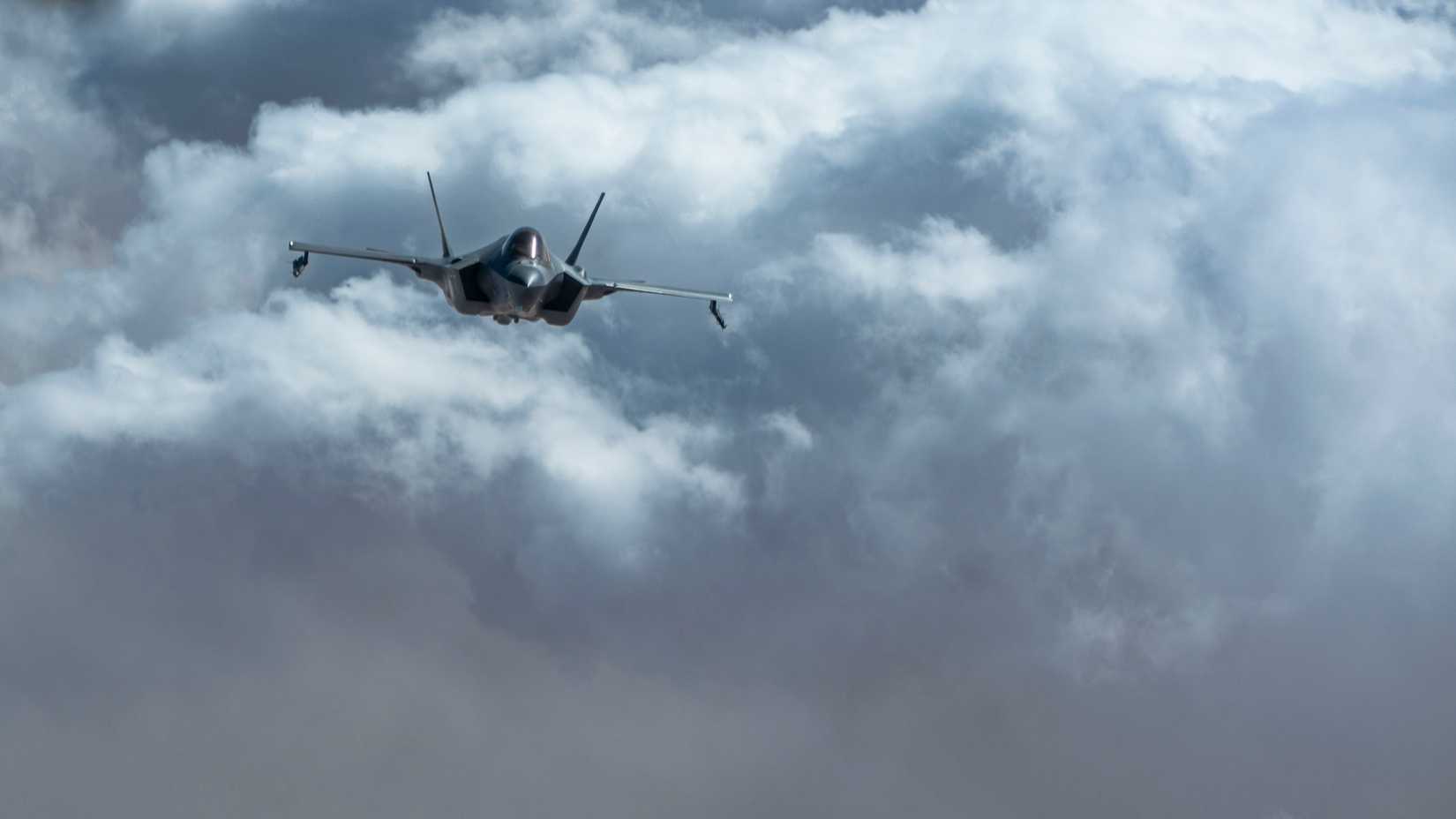 Air Force F-35 Lightning II approaches a KC-135 Stratotanker for refueling.