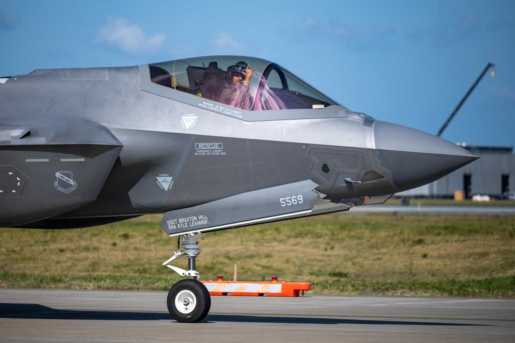 Air Force pilot assigned to the 421st Fighter Squadron holds up the Wild Weasel hand sign in an F-35A Lightning II in support of Exercise Bushido Guardian 2025.