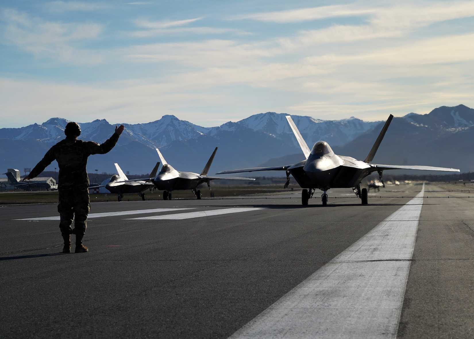 Air Force Staff Sgt. Christopher Graham, 3rd Wing crew chief, marshalls an F-22 Raptor on the flight line at Joint Base Elmendorf-Richardson, Alaska,.