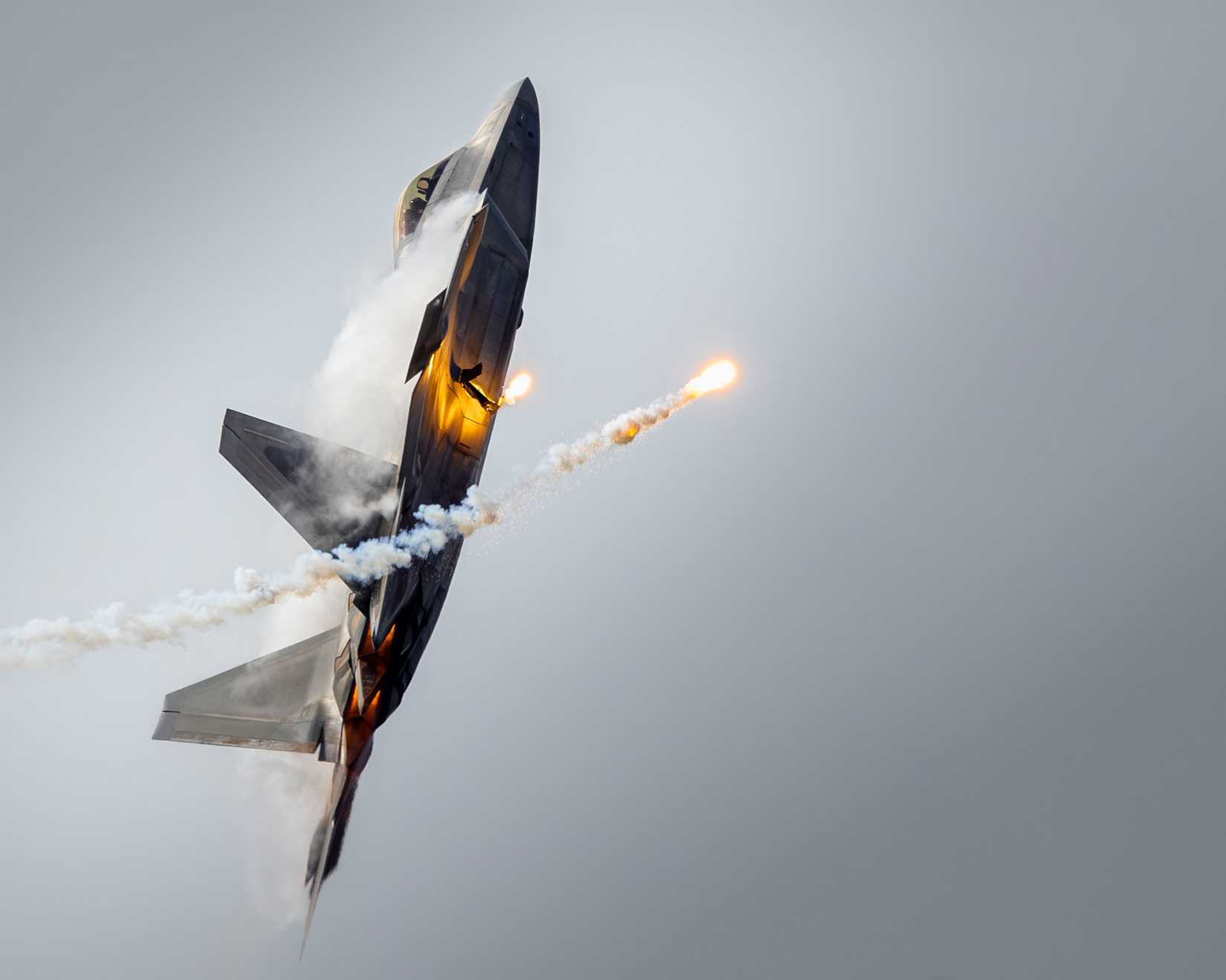 An F-22 Raptor releases flares during an aerial demonstration at Naval Air Station Oceana, Virginia, Sept. 21, 2025.