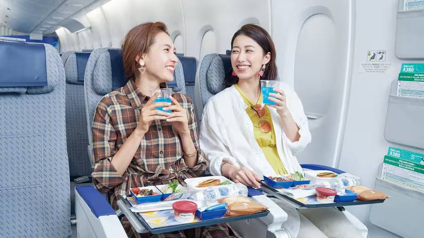 ANA passengers in economy enjoyng a meal