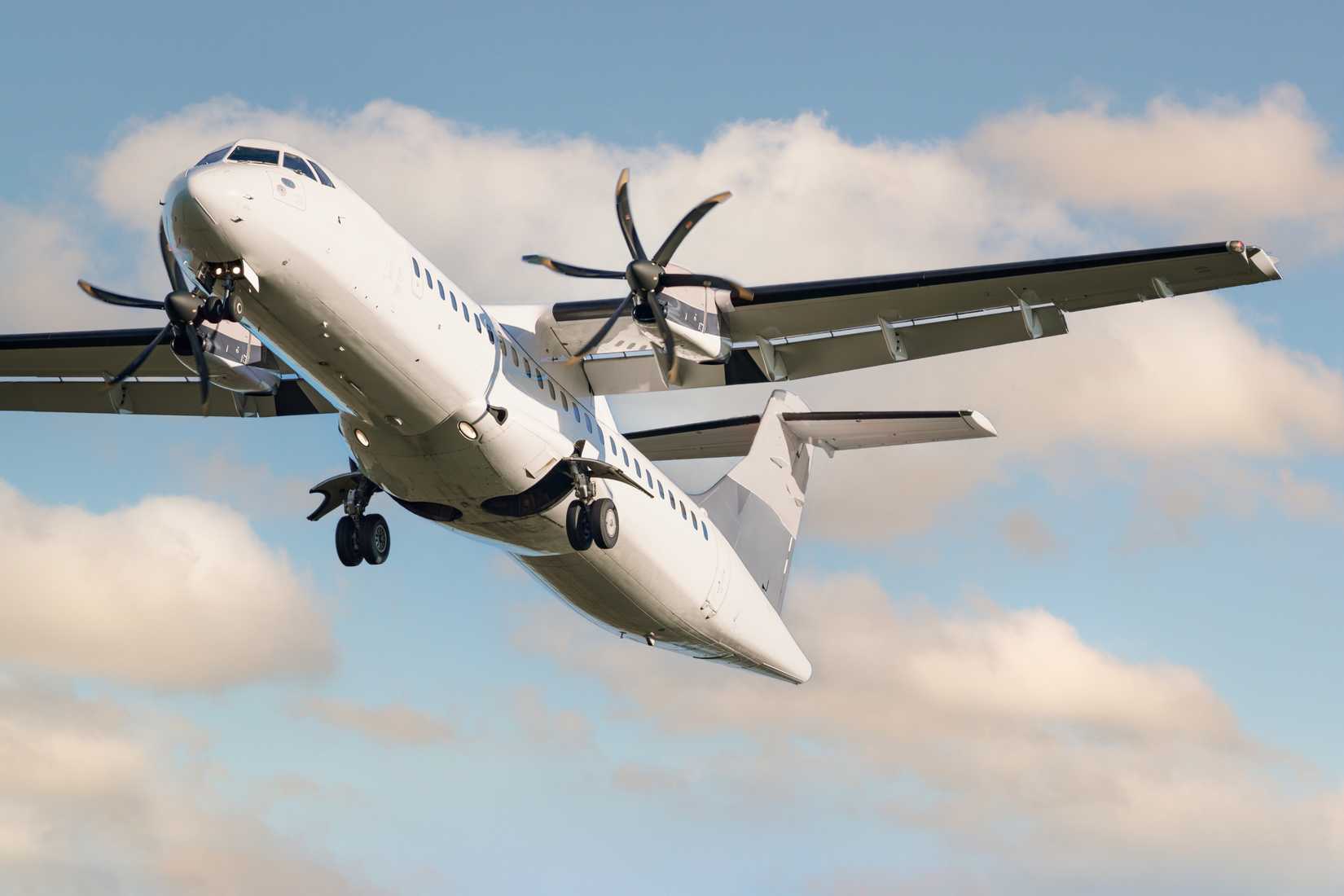 ATR 72 airplane among the clouds.