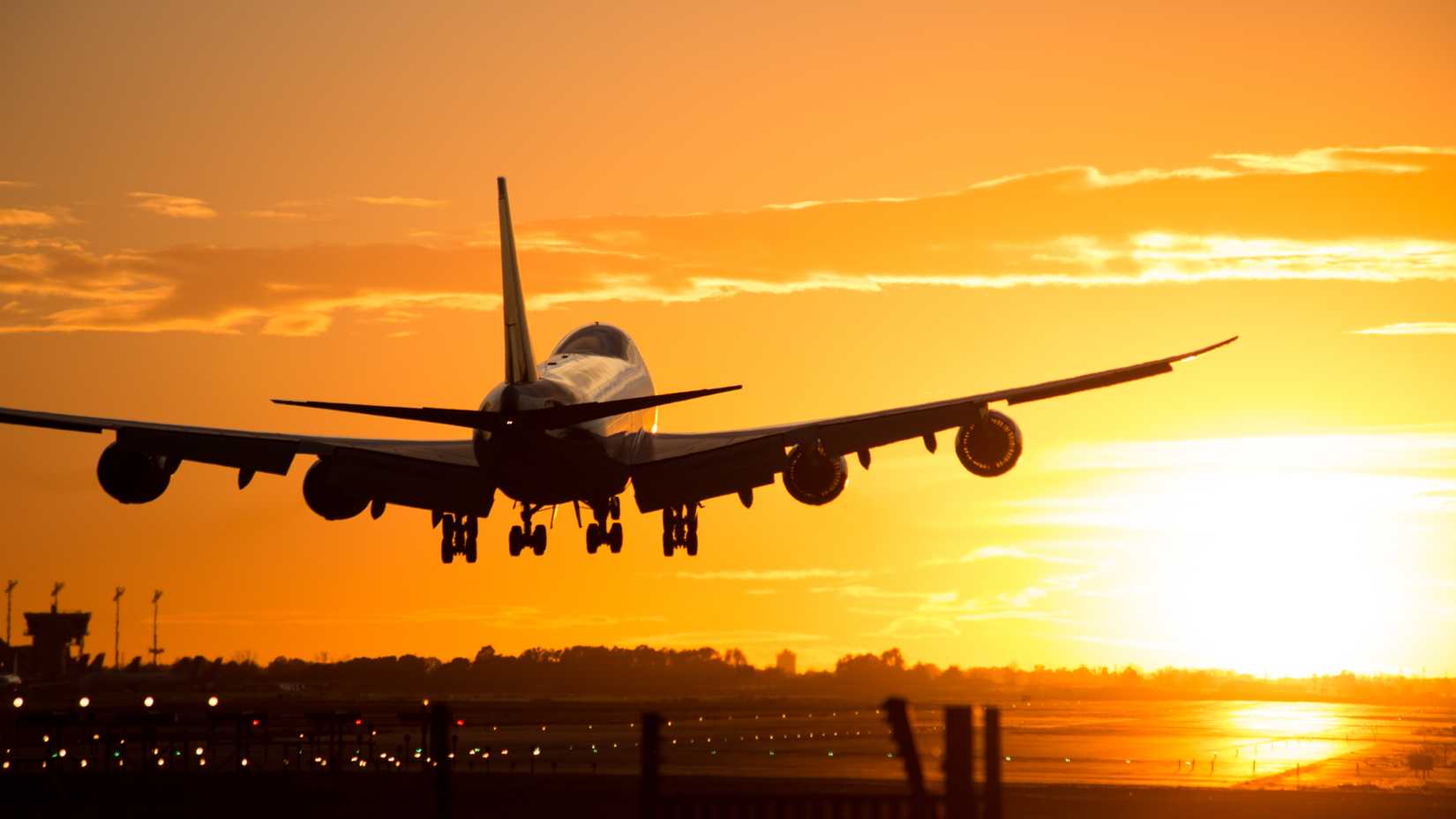 Boeing 747 landing at Barcelona in a golden sunset