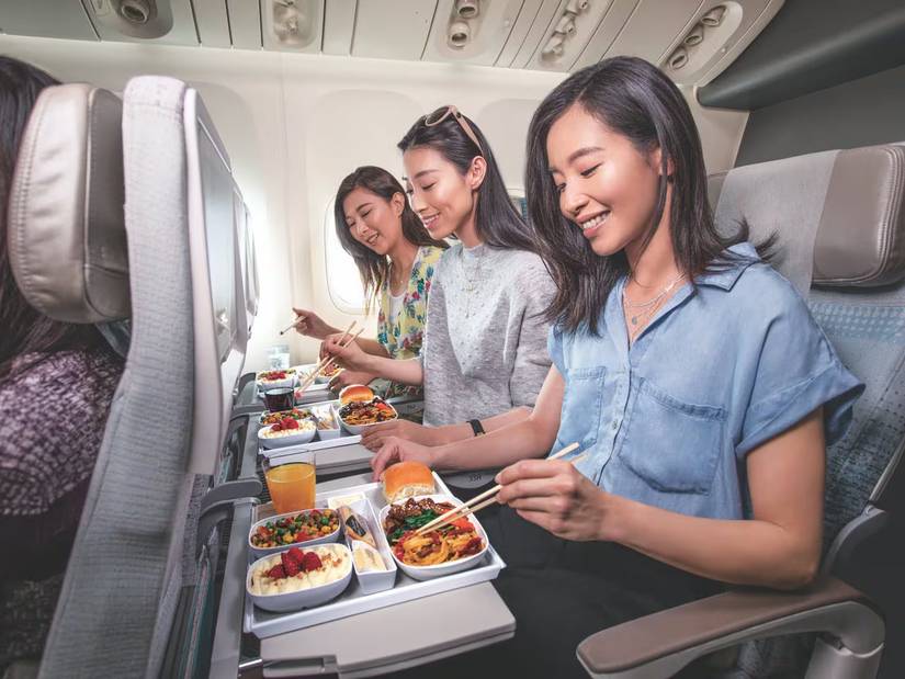 emirates airlines passengers in economy eating a meal