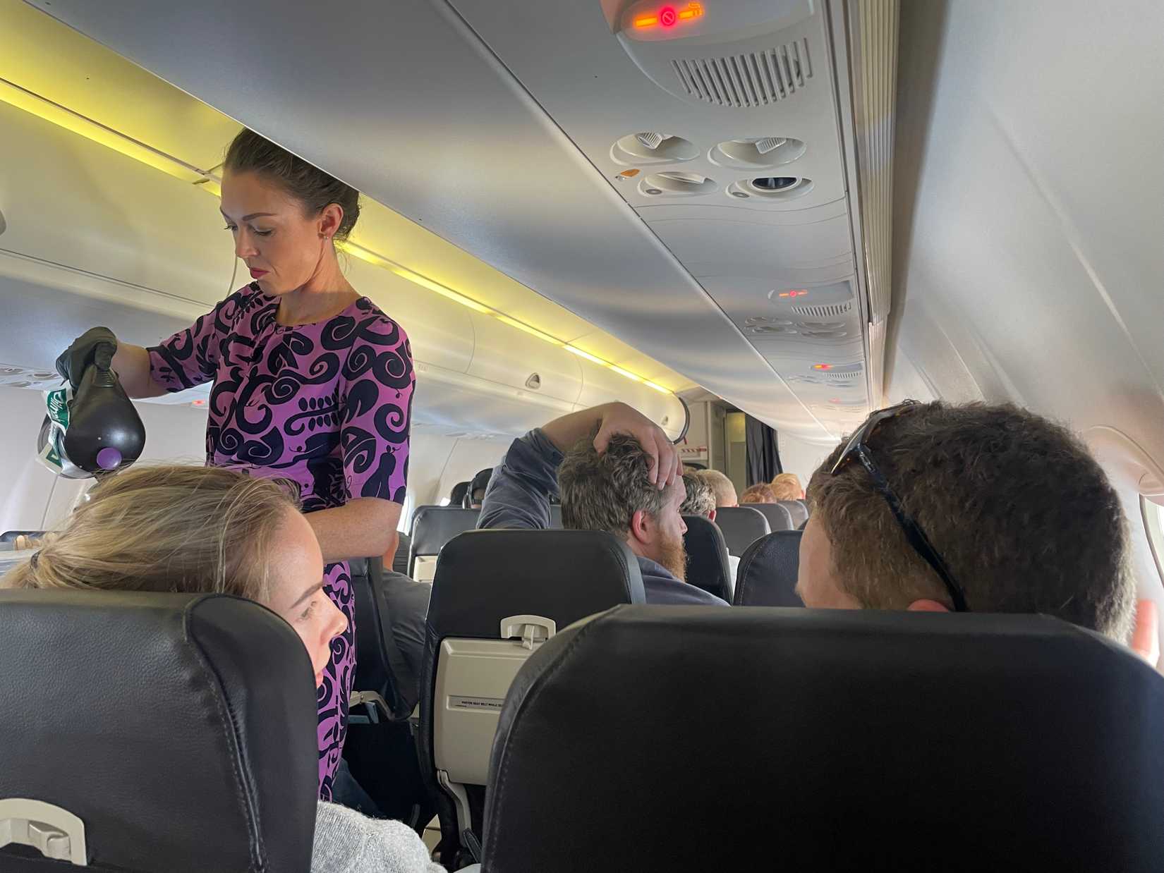 Air NZ Q300 flight attendant serving