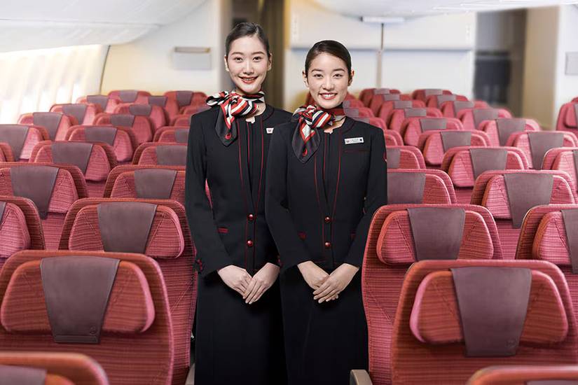 Japan Airlines teo flight attendants in economy cabin