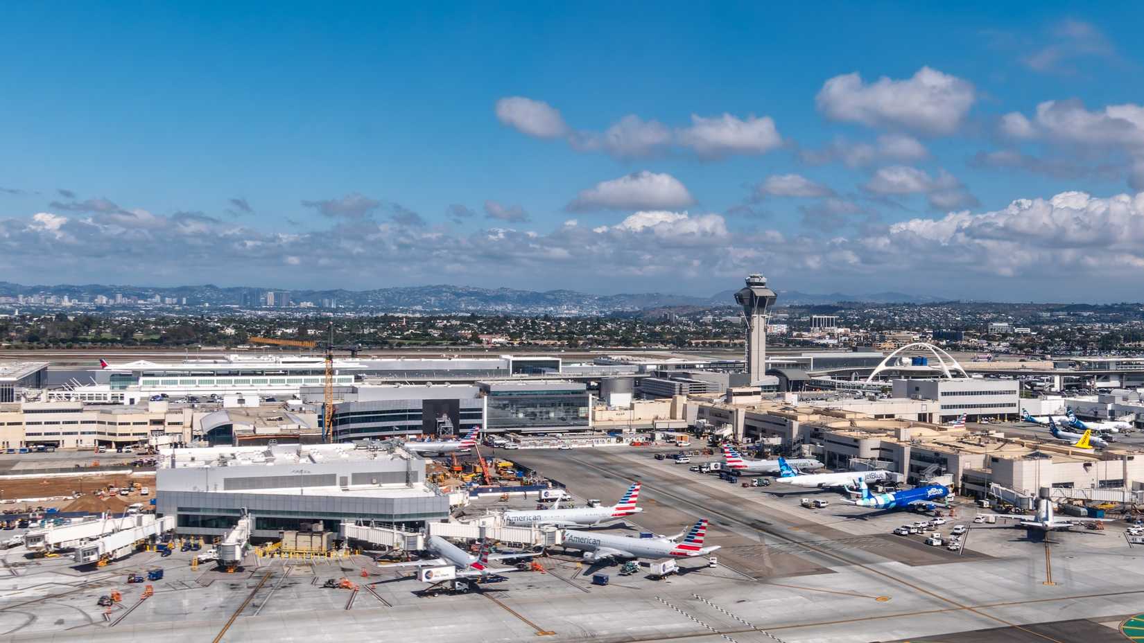 Los Angeles International Airport (LAX) viewed from above with The Theme Building and Air Traffic Control Tower in view.