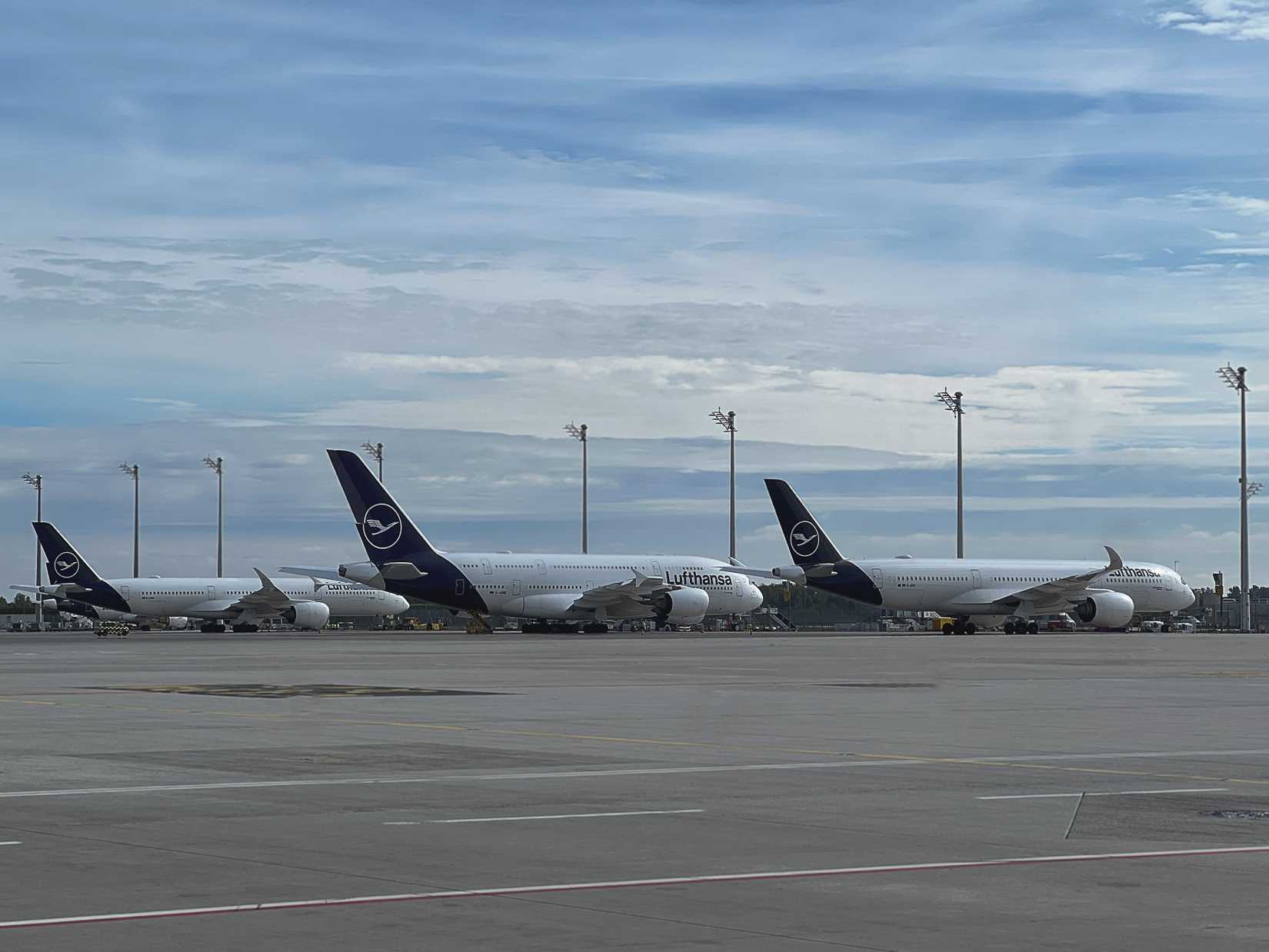 Lufthansa Airbus A350 and A380 parked on apron infrastructure at Munich airport taken on 11 October 2025.