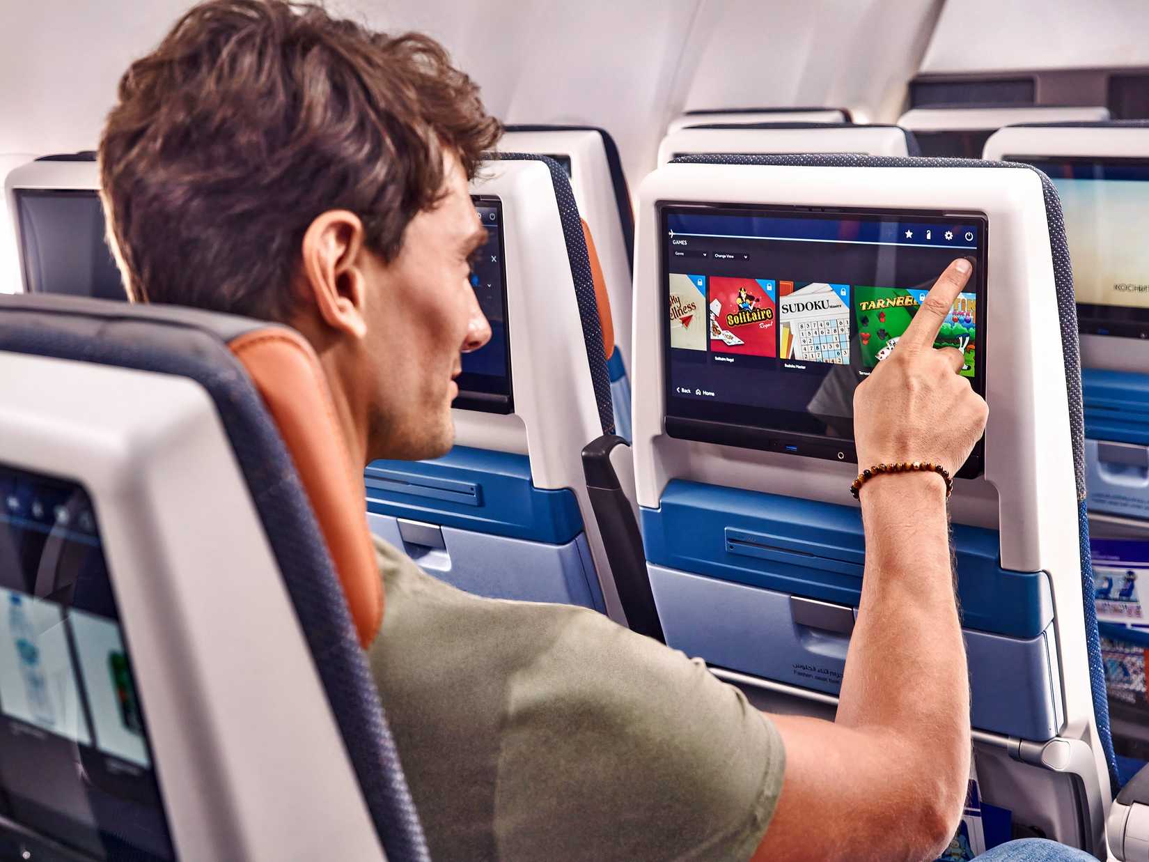 A flydubai passenger uses the IFE system in the economy cabin
