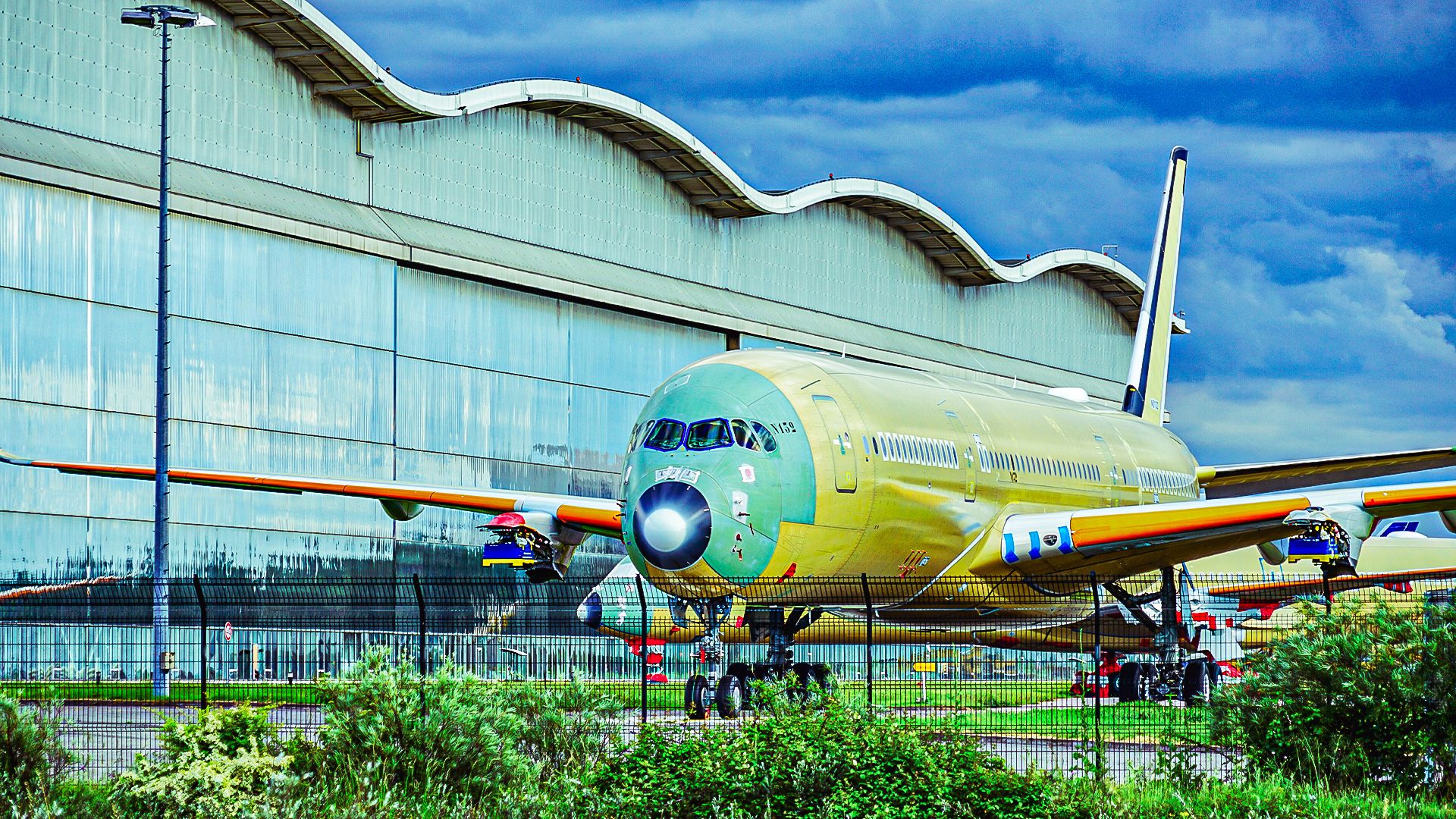 An aeroplane sitting outside Airbus's factory under construction