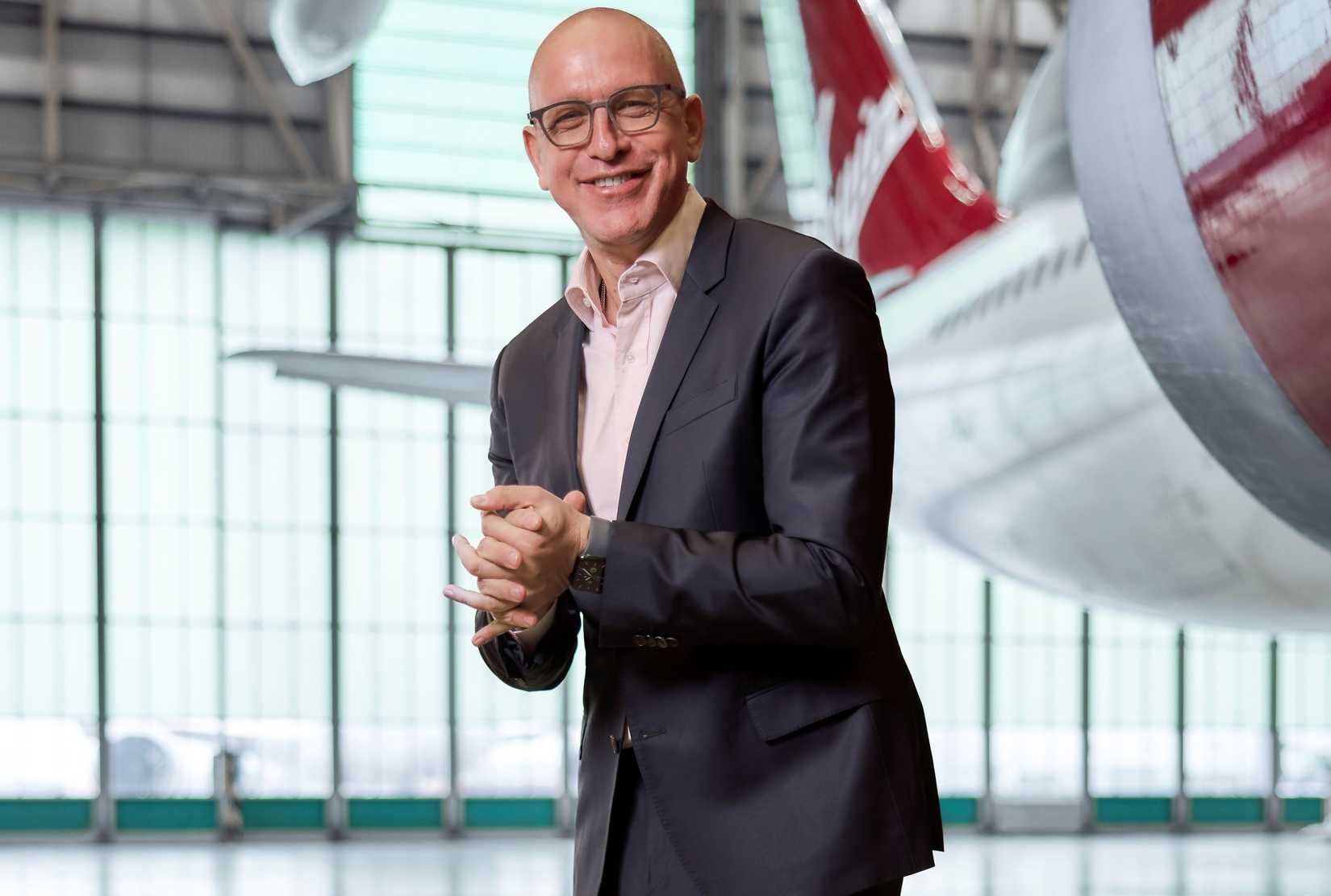 Shai Weiss Standing In Front Of Virgin Atlantic Tail In Hangar