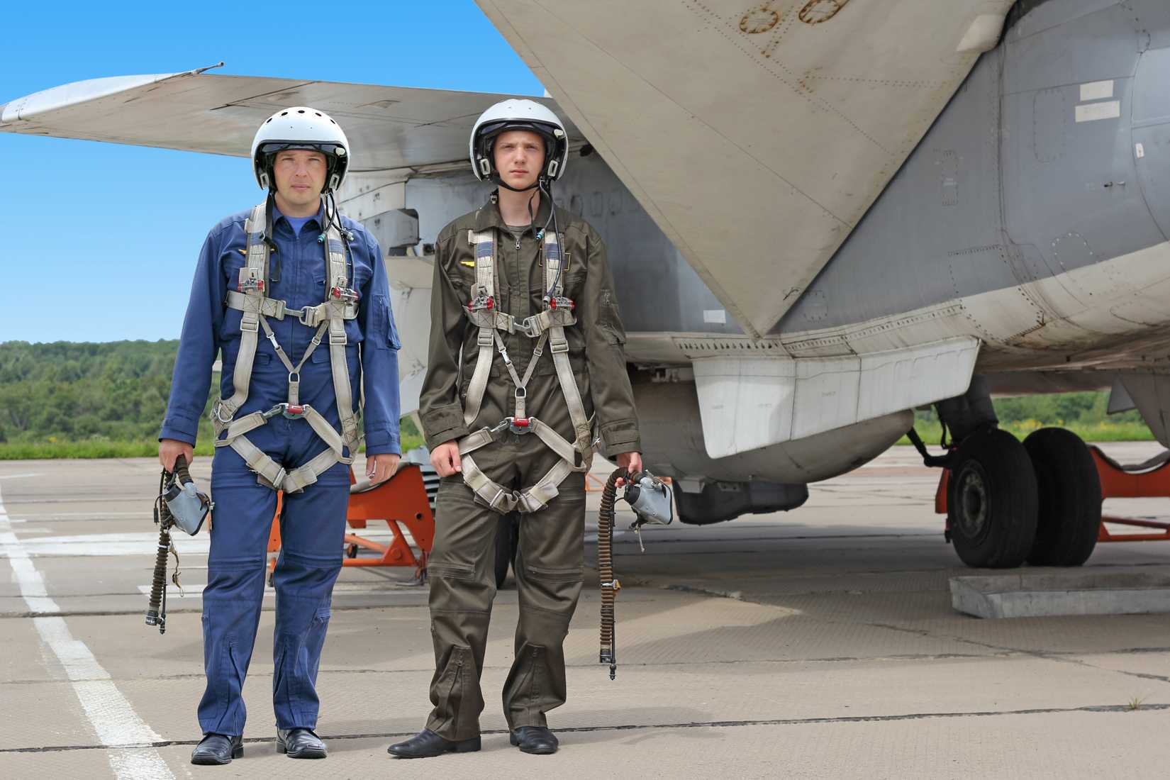 Two Russian pilots posing near a Sukhoi Su-24 Fencer