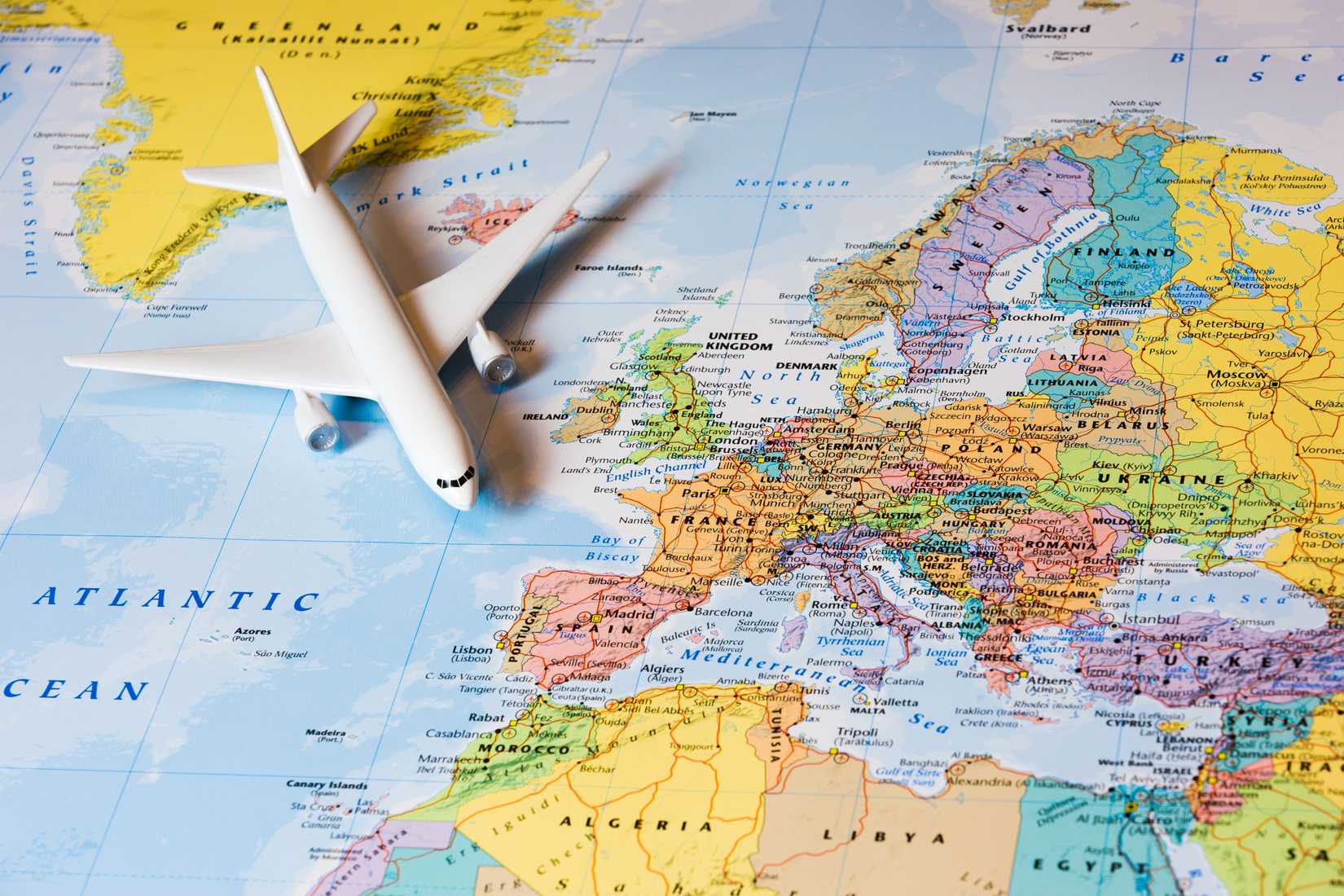 A political map of Europe with a model airplane on top