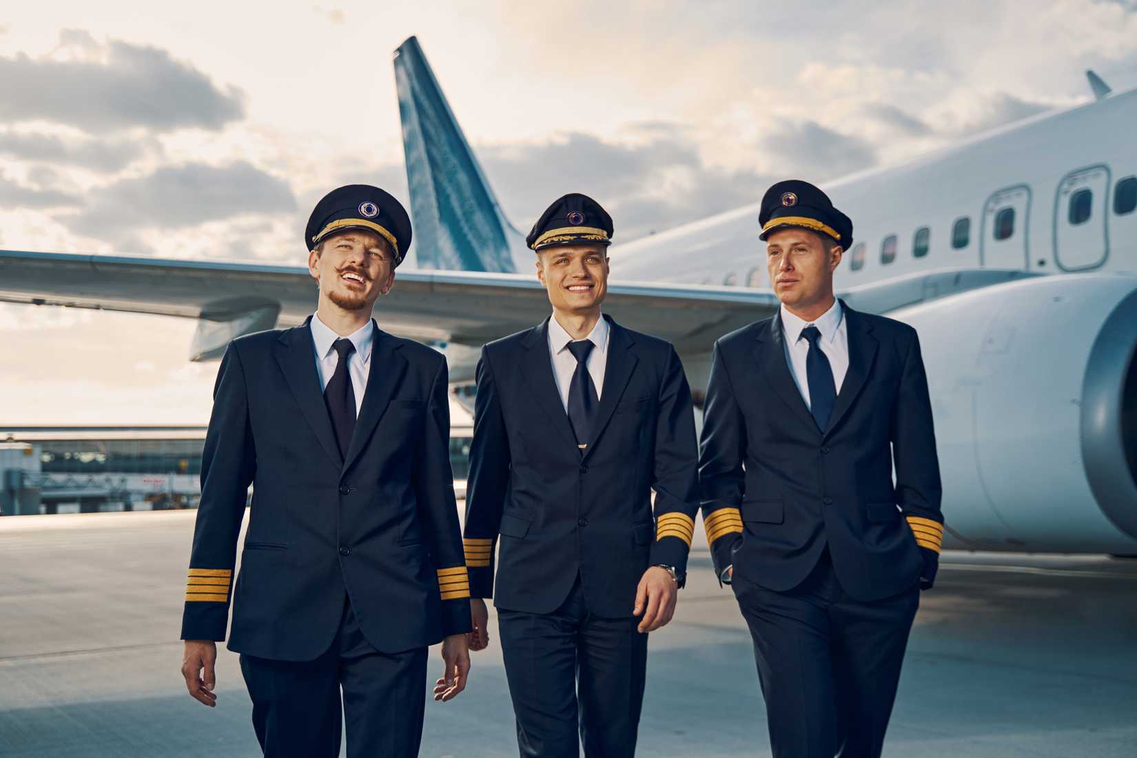 3 Captains walking by aircraft