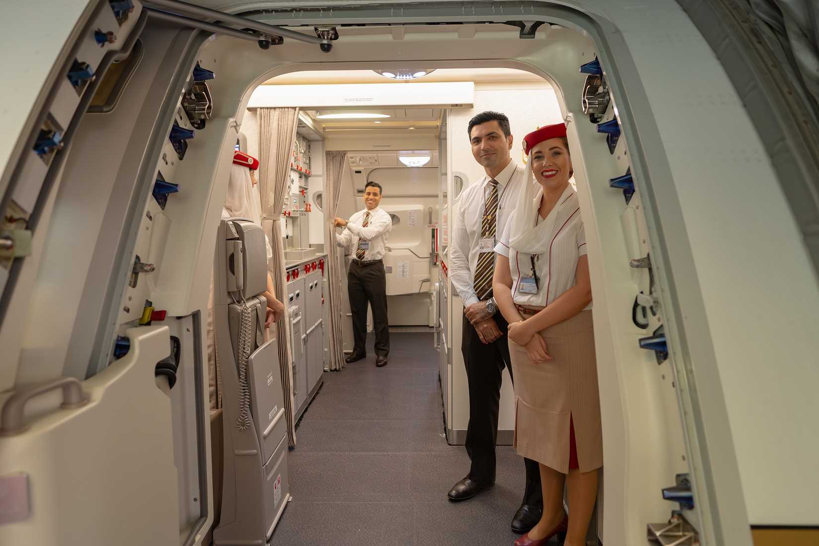 Emirates cabin crew boarding passengers
