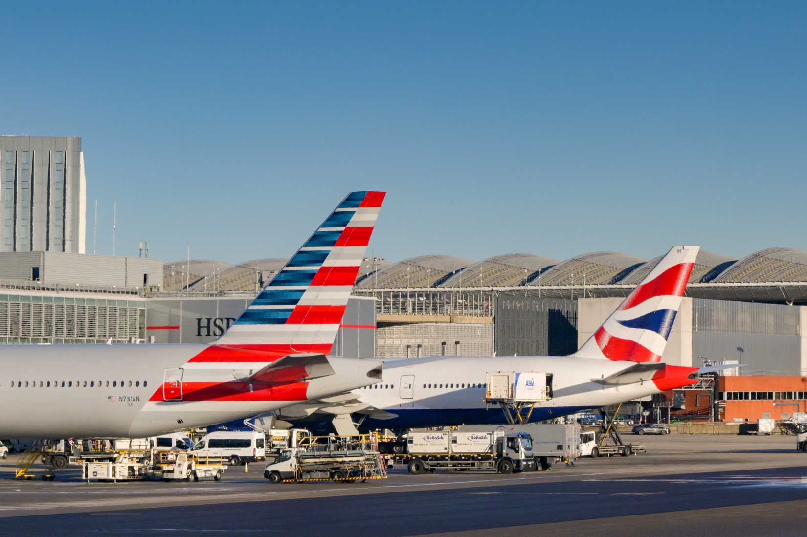 American Airways and British Airways Tails parked at gate. Both oneworld alliace members.