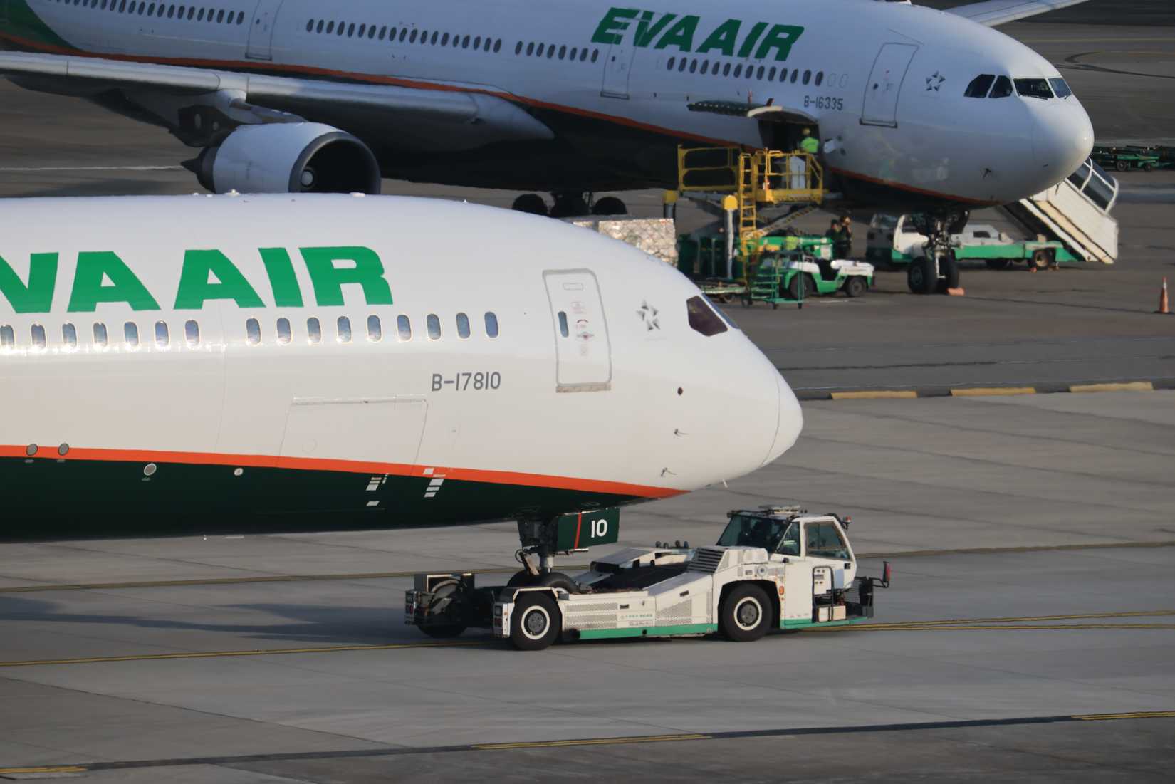EVA Air Boeing 787-10 being towed on the tarmac, with an Airbus A330 in the background during ground handling operations