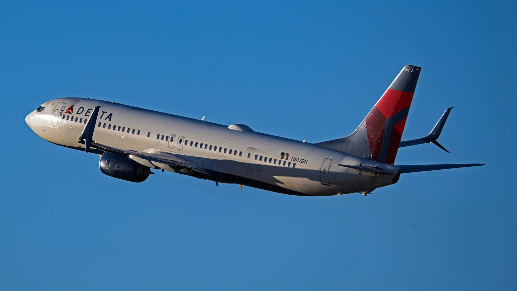 Delta Air Lines Boeing 737 in flight blue sky