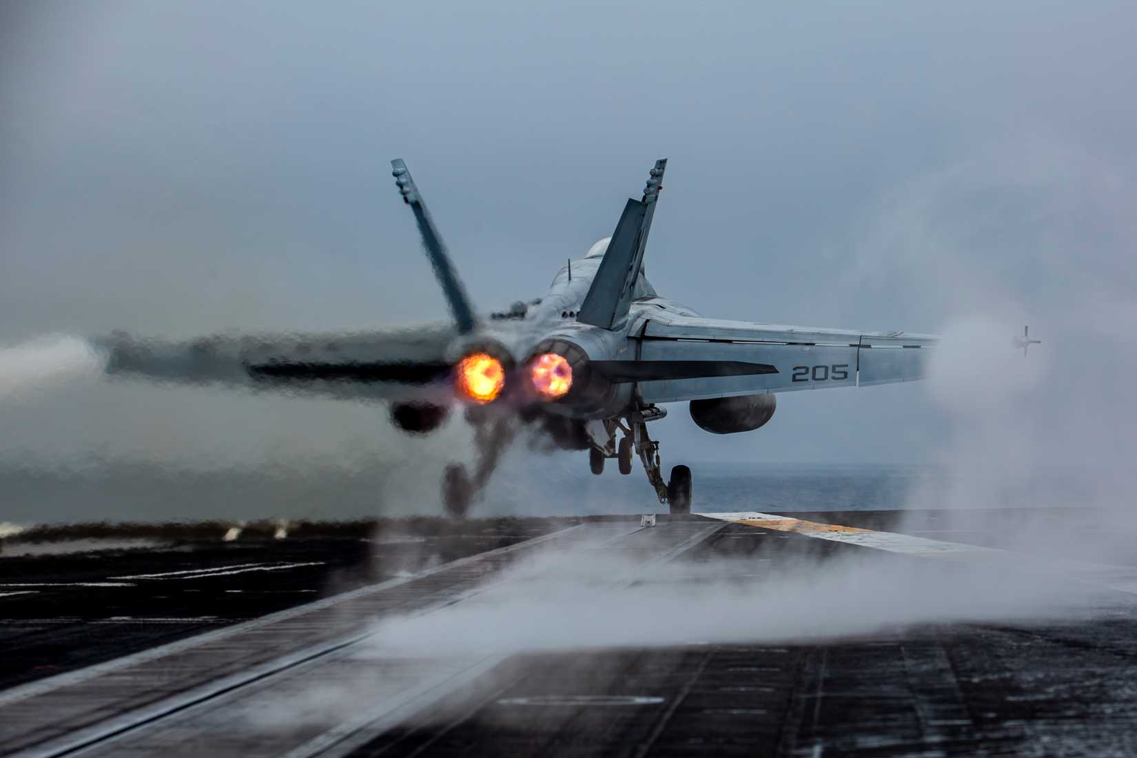 Super Hornet, attached to Strike Fighter Squadron (VFA) 14, launches from the flight deck of the Nimitz-class aircraft carrier USS Abraham Lincoln (CVN 72).