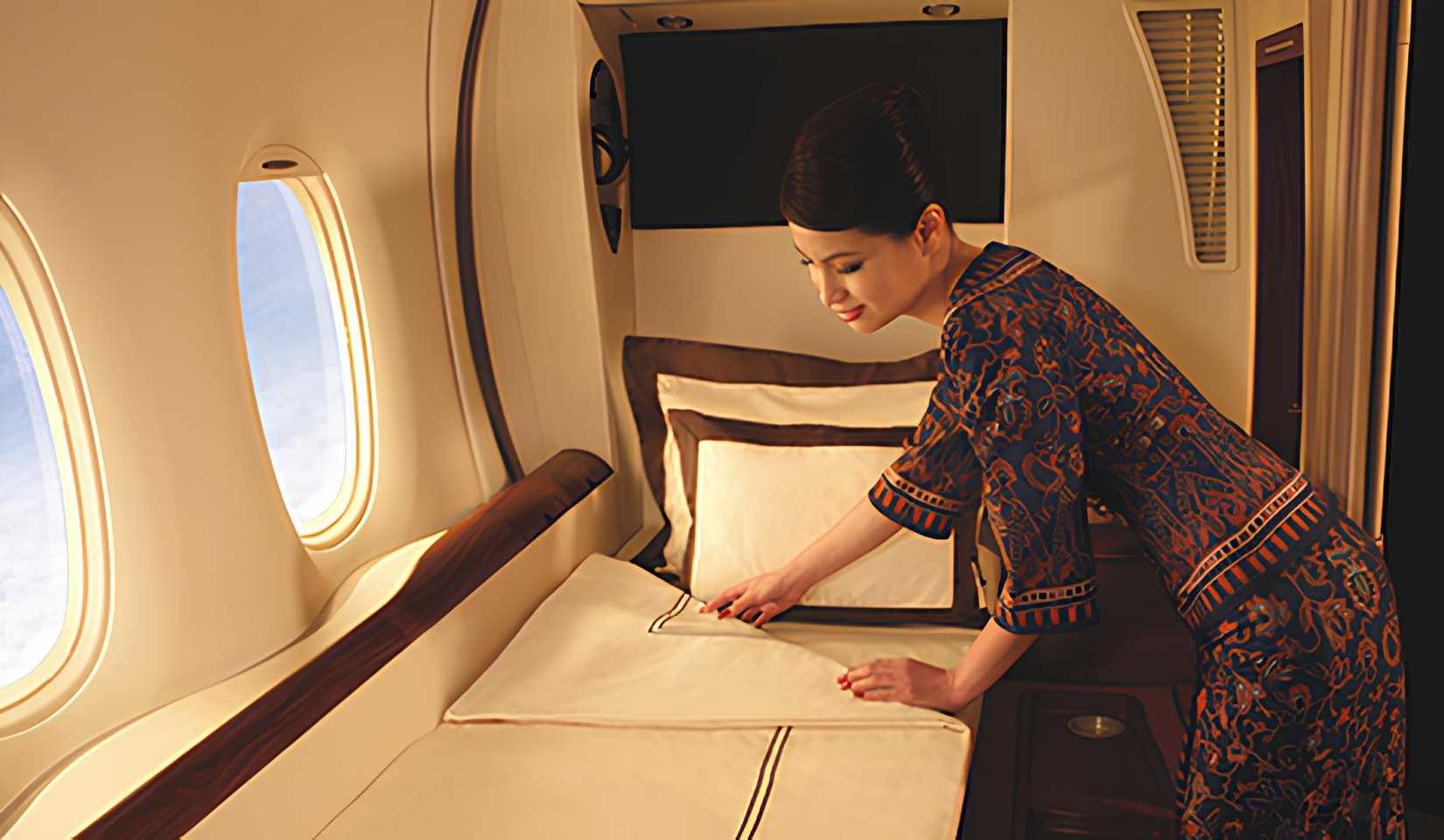 Singapore Airlines cabin crew setting the bed in first class of A380