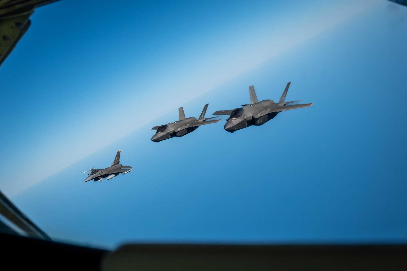 Two Royal Australian Air Force (RAAF) F-35A Lightning IIs and a U.S. Air Force F-16 Fighting Falcon.
