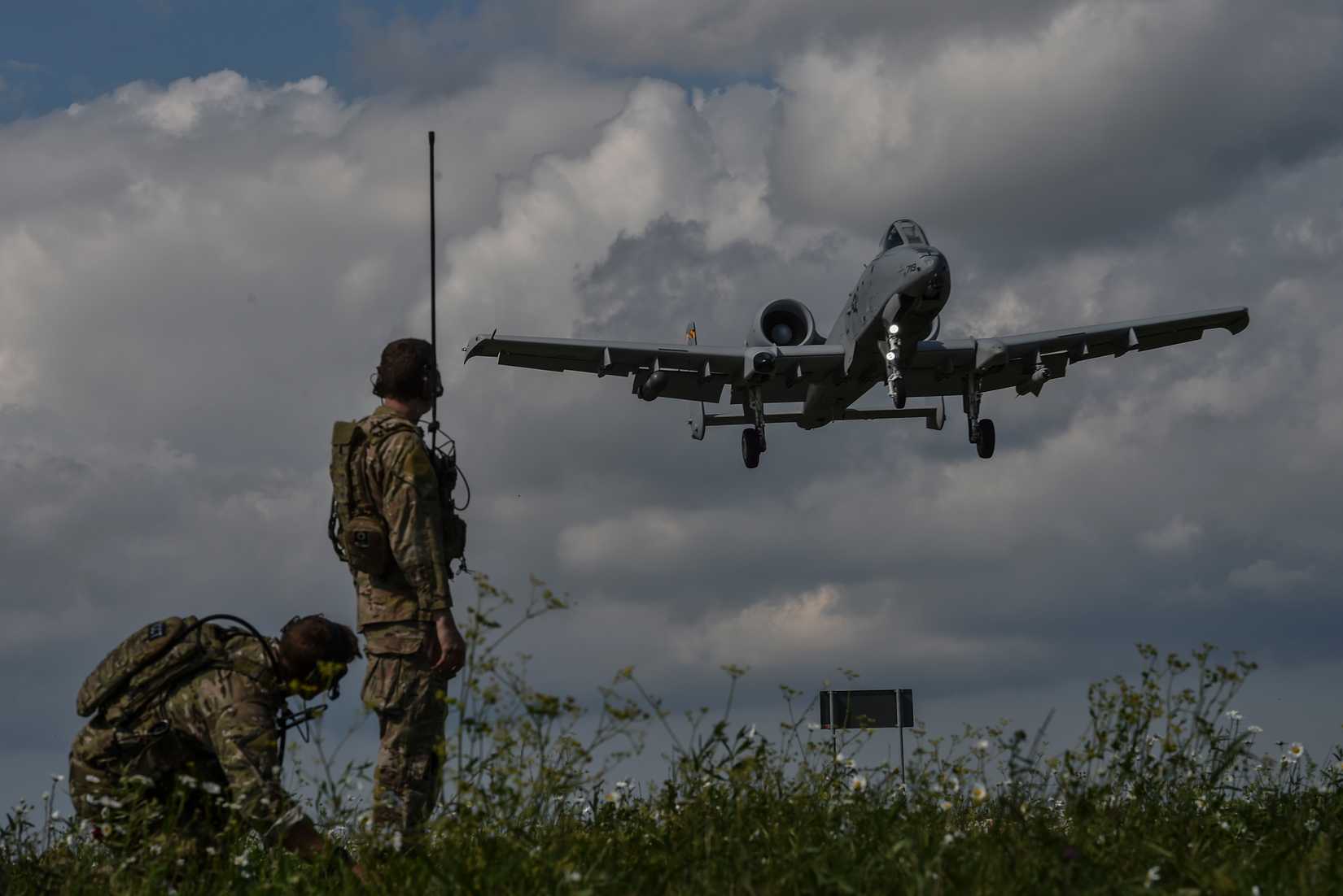 Two combat controllers with the 321st Special Tactics Squadron observe an A-10 Thunderbolt II landing on Jägala-Käravete Highway, Aug. 10, in Jägala, Estonia