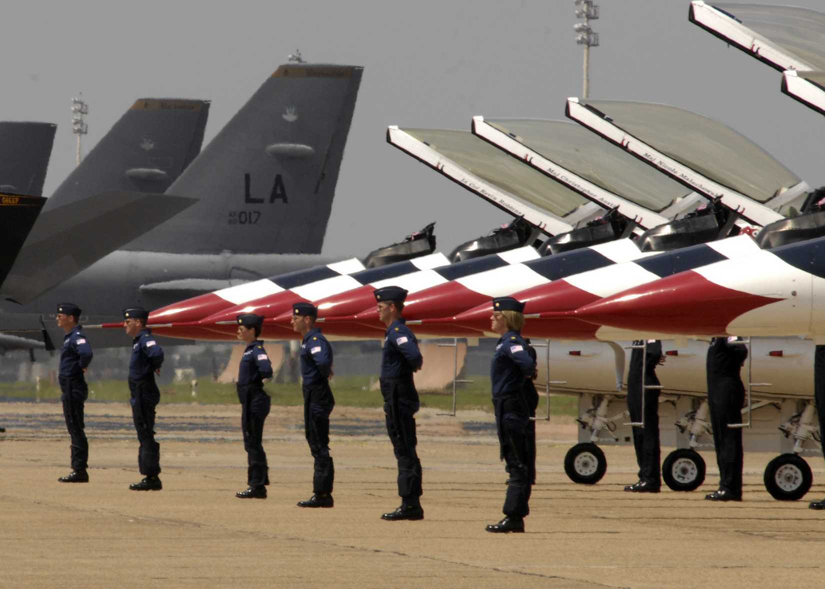 USAF thunderbird pilots lined up beneath their F-16