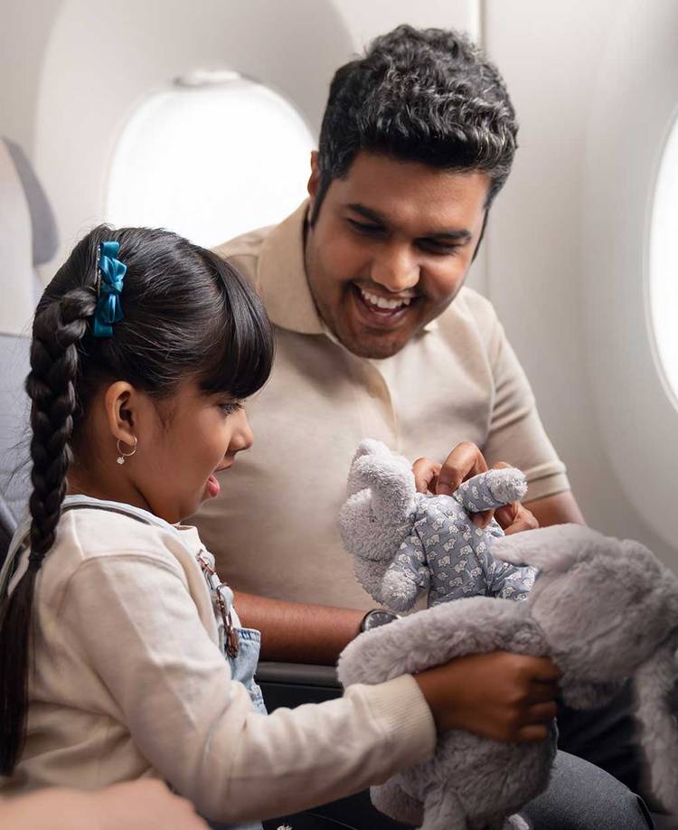 Parent and child seated in aircraft
