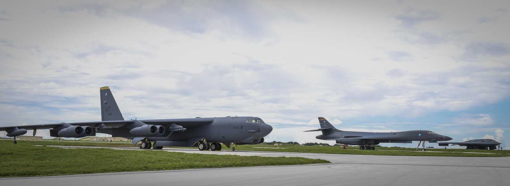 A B-52 Stratofortress, B-1B Lancer and B-2 Spirit sit beside one another on the flightline at Andersen Air Force Base, Guam