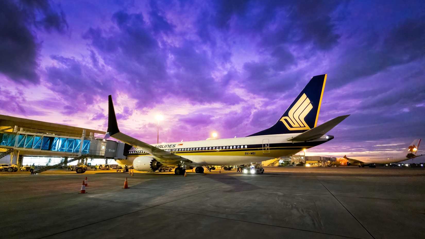 Singapore Airlines airplane at gate at night time