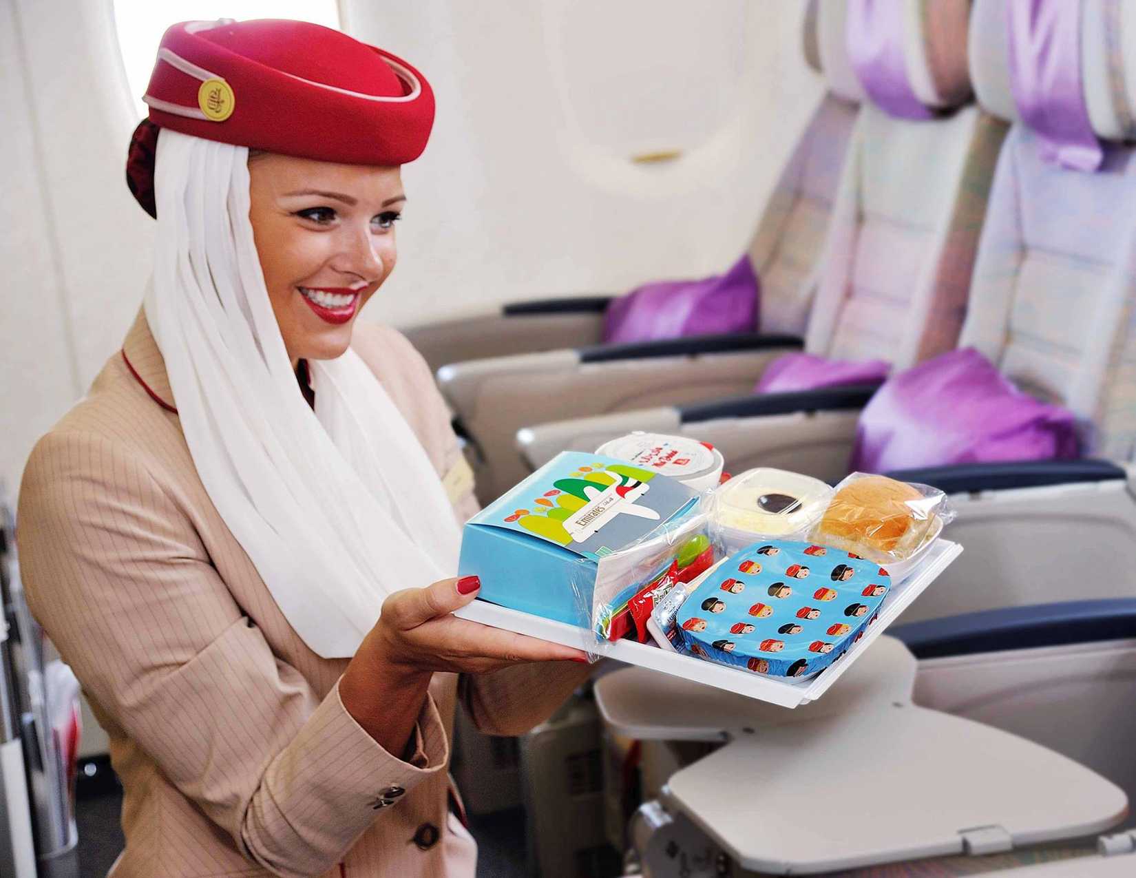 Emirates cabin crew serving childs meal