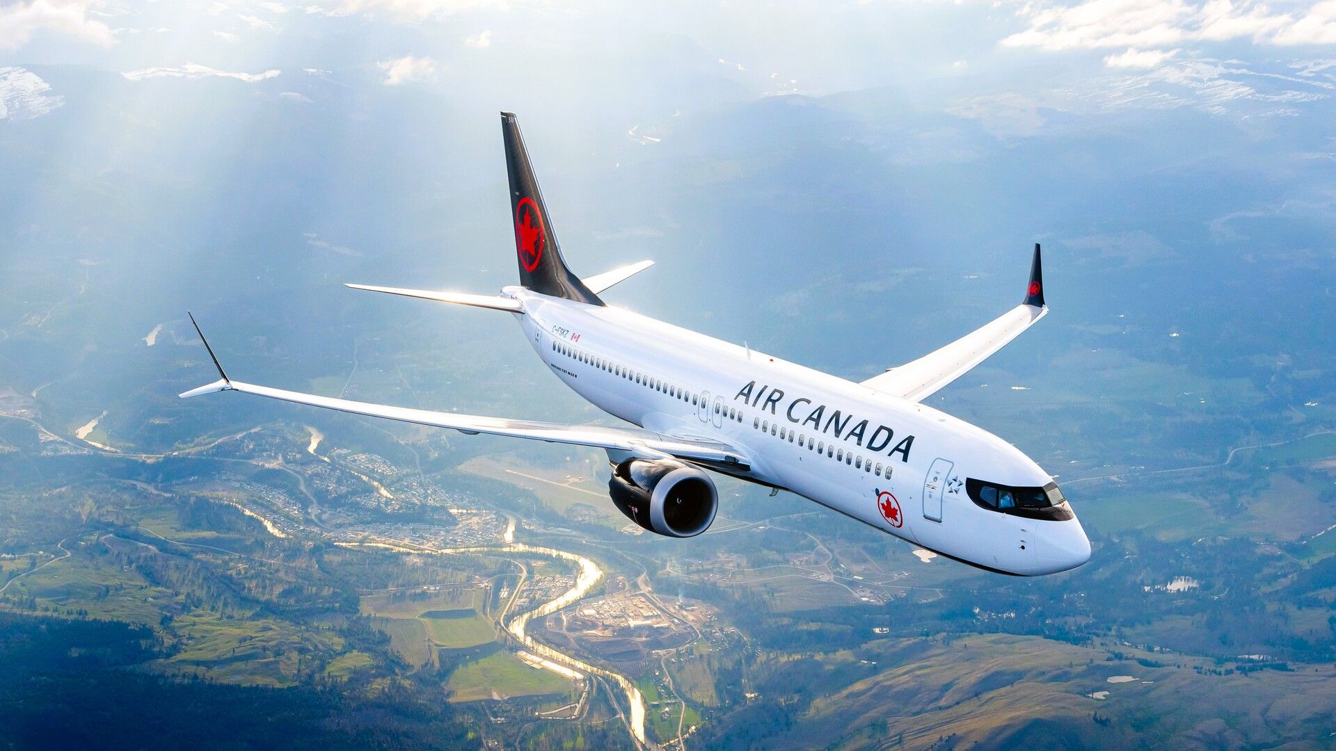 Air Canada Boeing 737 MAX 8 cruising over valley