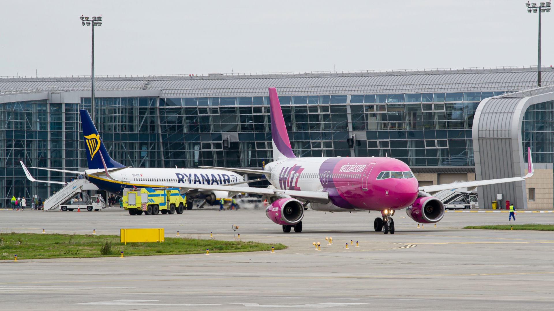 WizzAir Airbus A320 taxiing for takeoff from Lviv with Ryanair Boeing 737-800 in the background