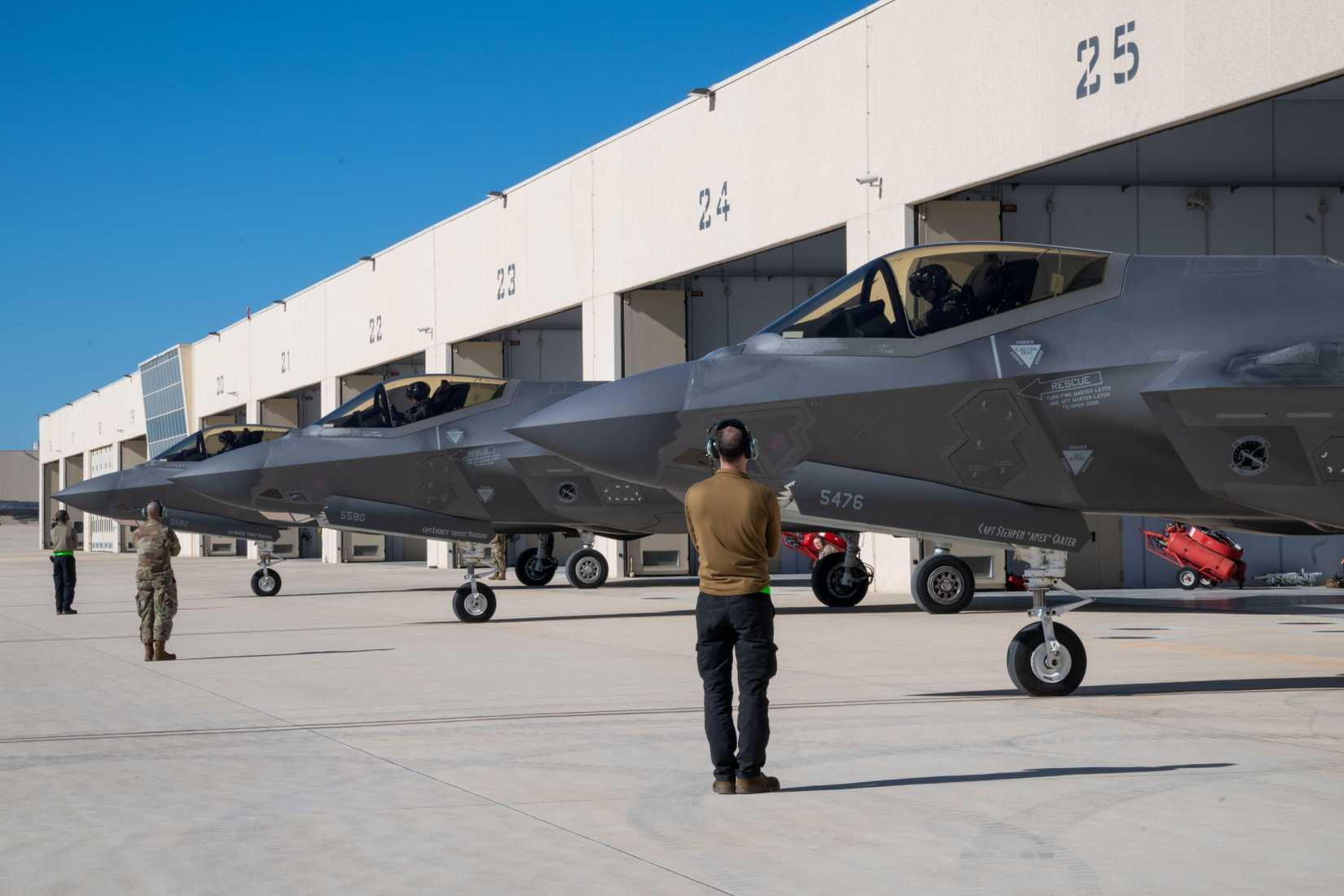 Air Force Airmen from the 495th Fighter Generation Squadron prepare to marshal F-35A Lightning II