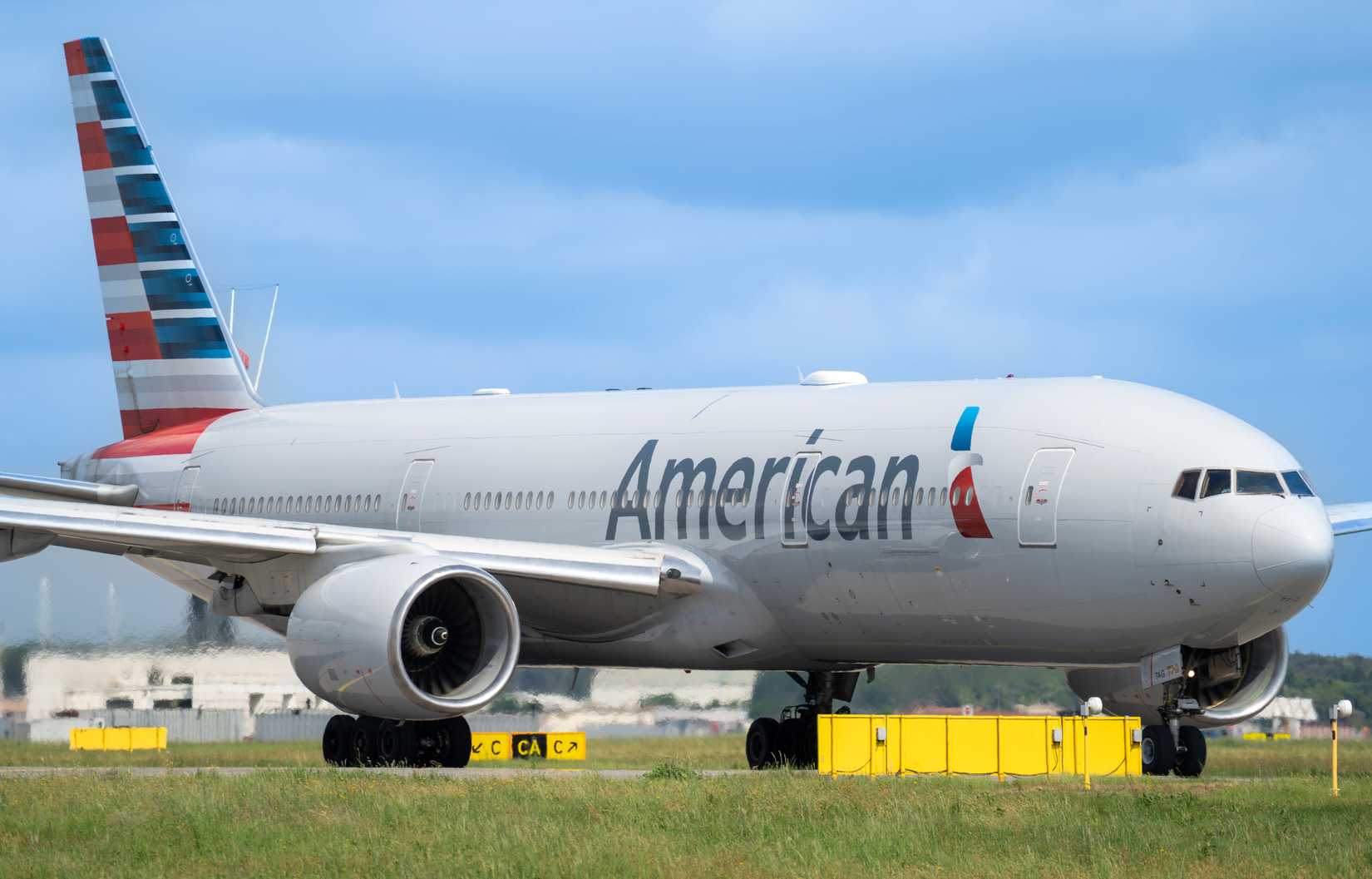 Boeing 777 American Airlines aircraft is taxiing at MXP Milano Malpensa international airport.