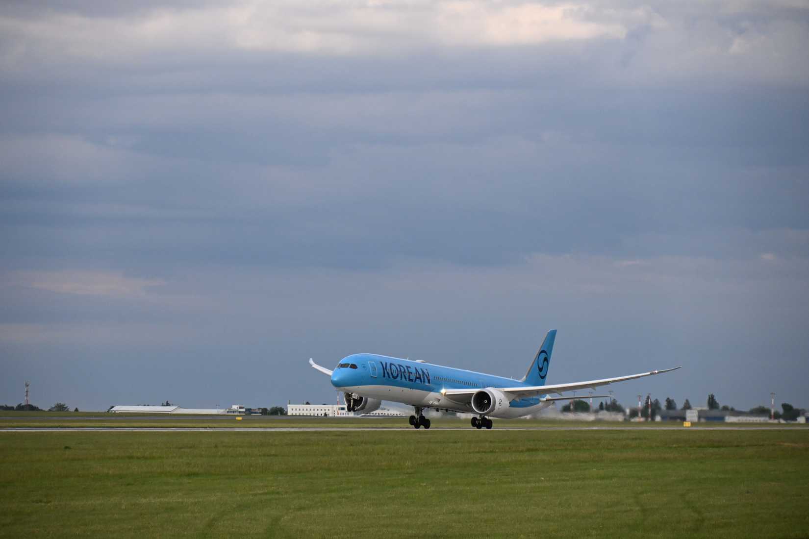 Boeing 787-10 Dreamliner (HL8515) lifting off from runway at Prague Airport.